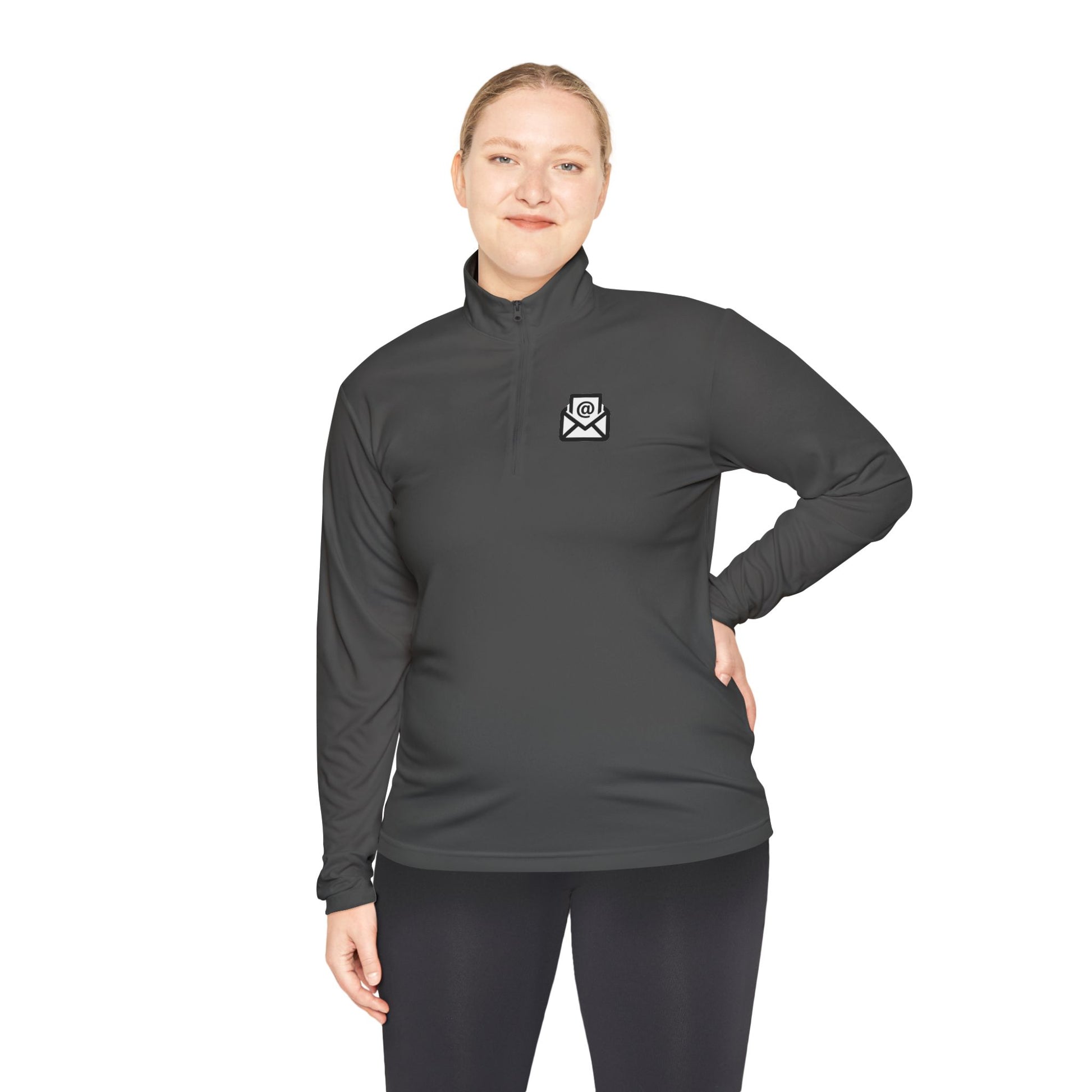 Woman modeling front of charcoal grey quarter-zip pullover, white envelope emblem, casual pose