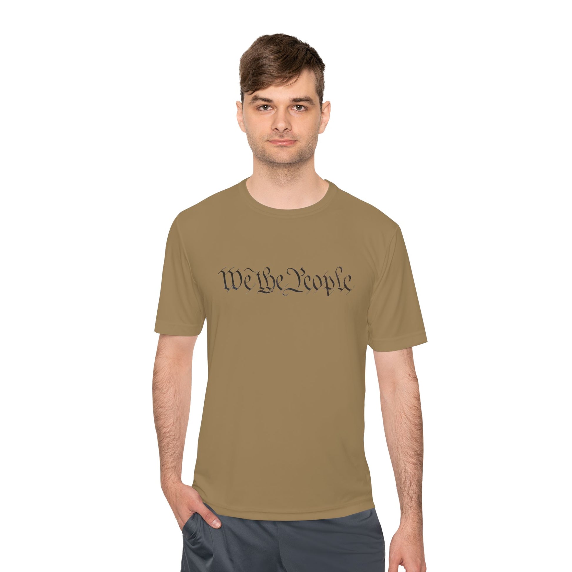 Guy owning the tan moisture-wicking tee, front black "We the People" script for patriot vibes