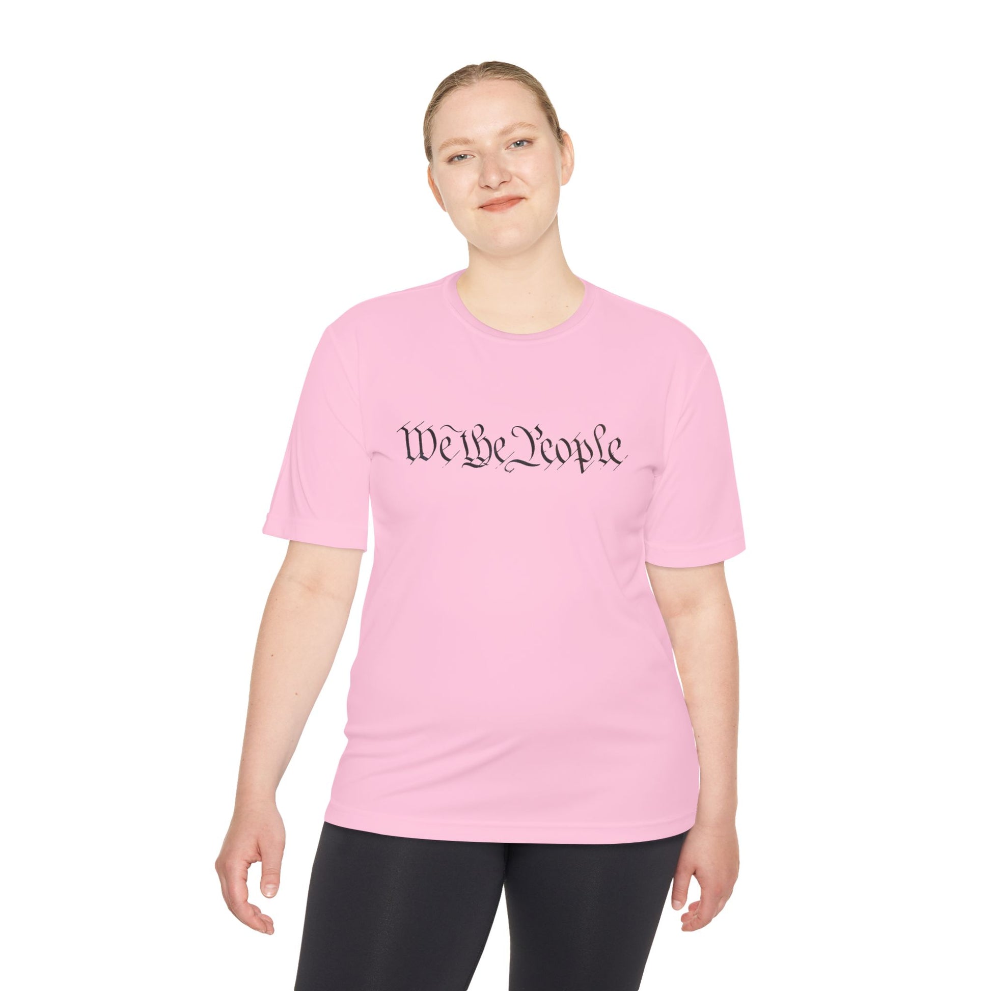 Female model front view in hot pink moisture-wicking tee with cursive "We the People" text