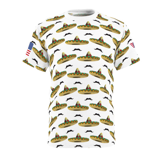 Front view of white unisex tee with all-over yellow sombrero-black mustache pattern, green accents, US flag left sleeve patch