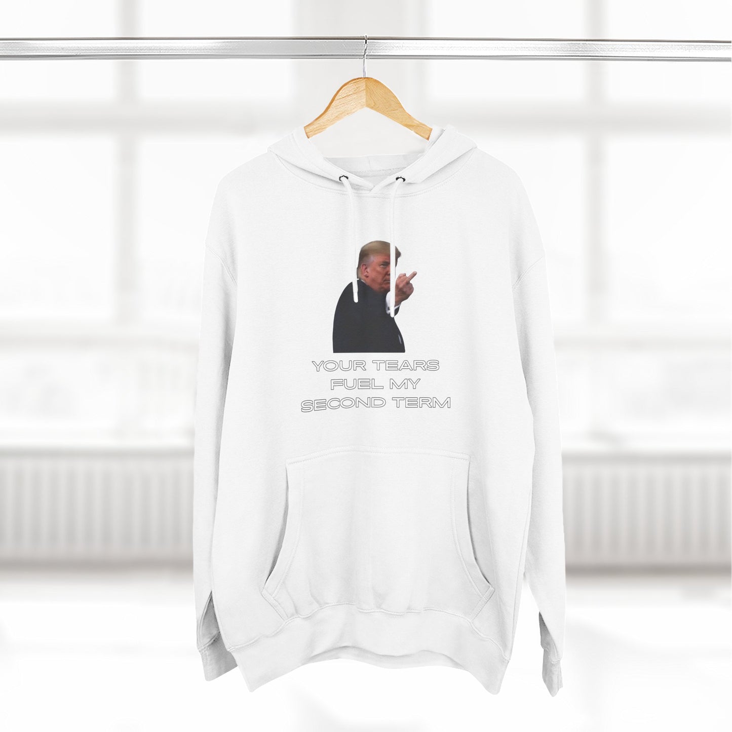 White Trump Plant Flip Off hoodie hanging on rack, front print popping with flip-off energy