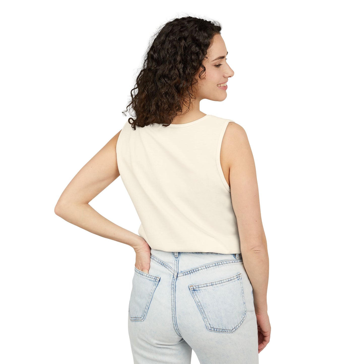 Side profile of woman in ivory tank top posing with jeans