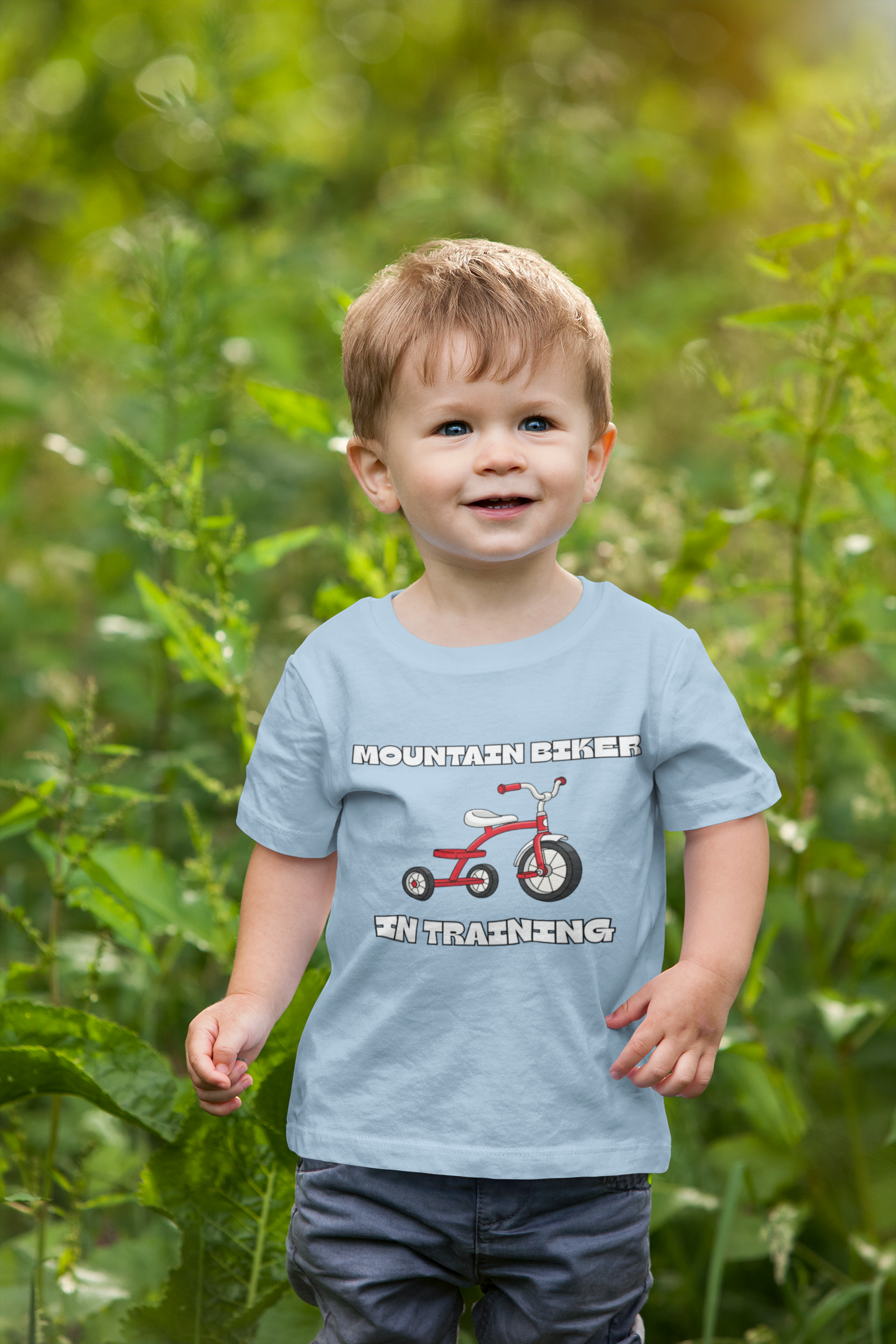 Toddler boy in charcoal 'Mountain Biker in training' tee with red tricycle - outdoor
