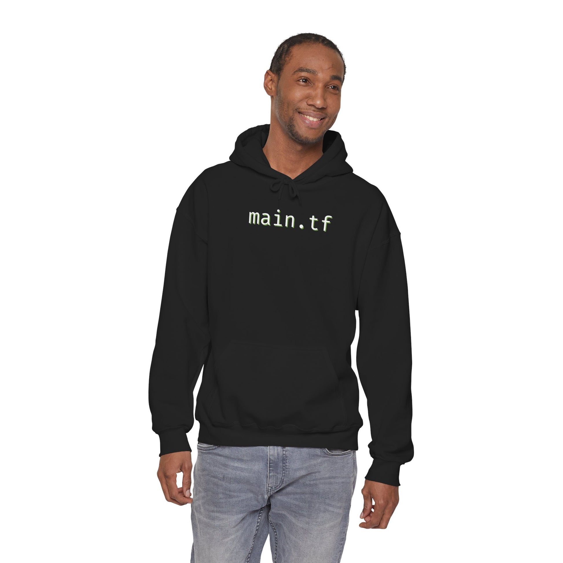 Model in black "main.tf" hoodie front view, hands in pockets, chill fit