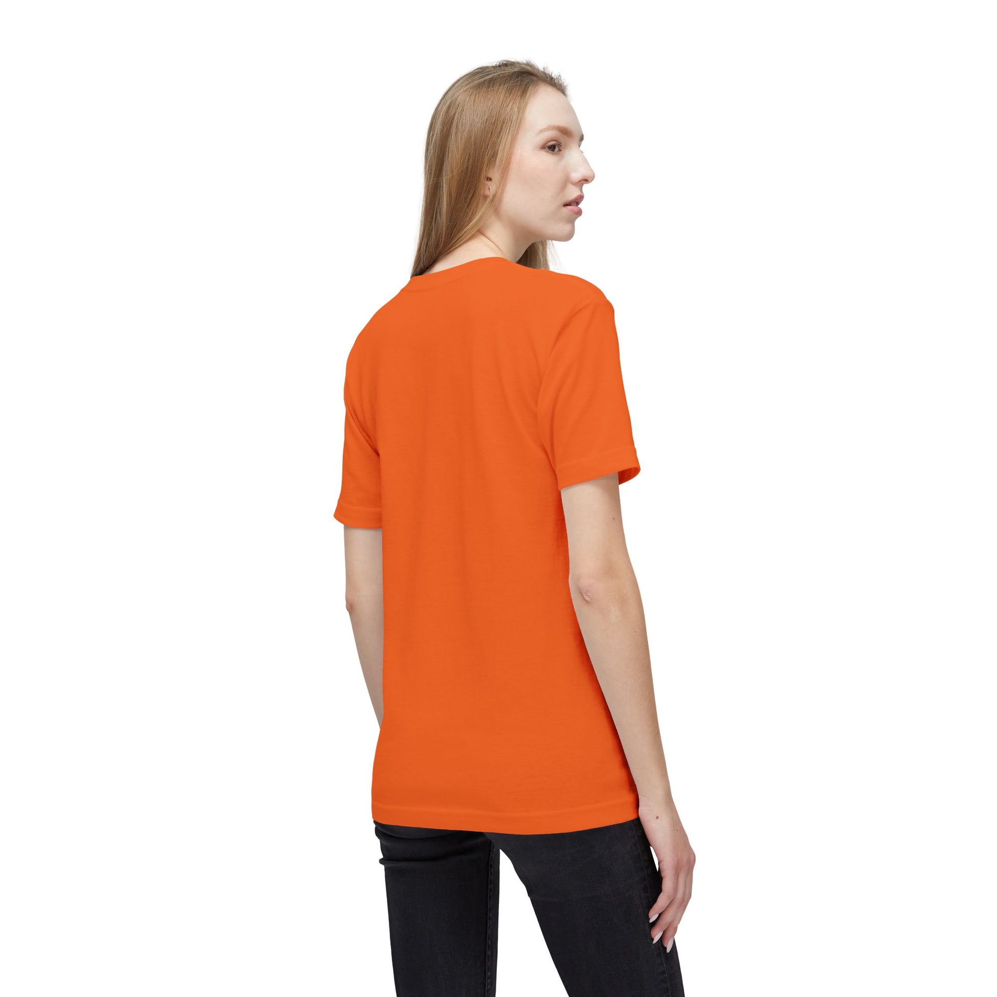 Side-back view of blonde model in plain bright orange unisex T-shirt and jeans
