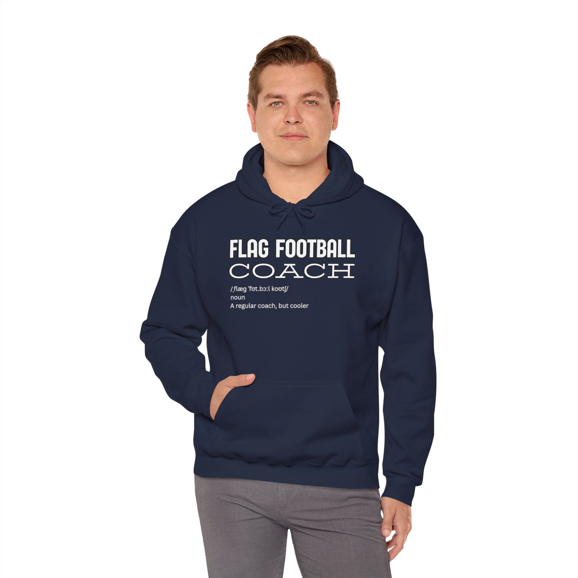 Male model front view rocking navy hoodie with bold white "FLAG FOOTBALL COACH" dictionary-style print