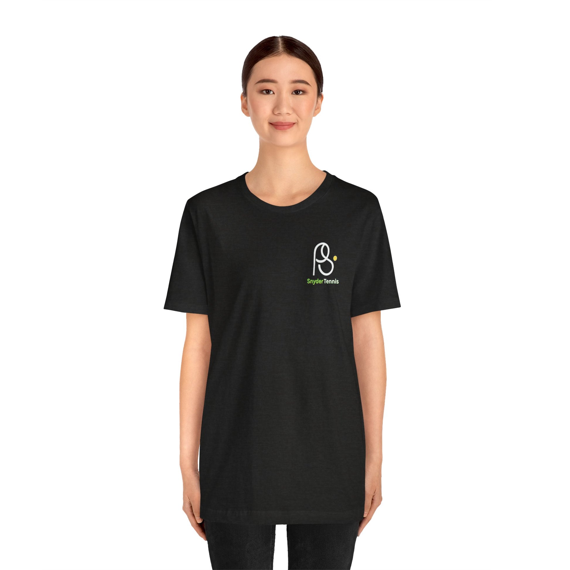 Smiling woman model in black Coach Pete Snyder tennis tee, white PS Harrison Tennis logo on left chest