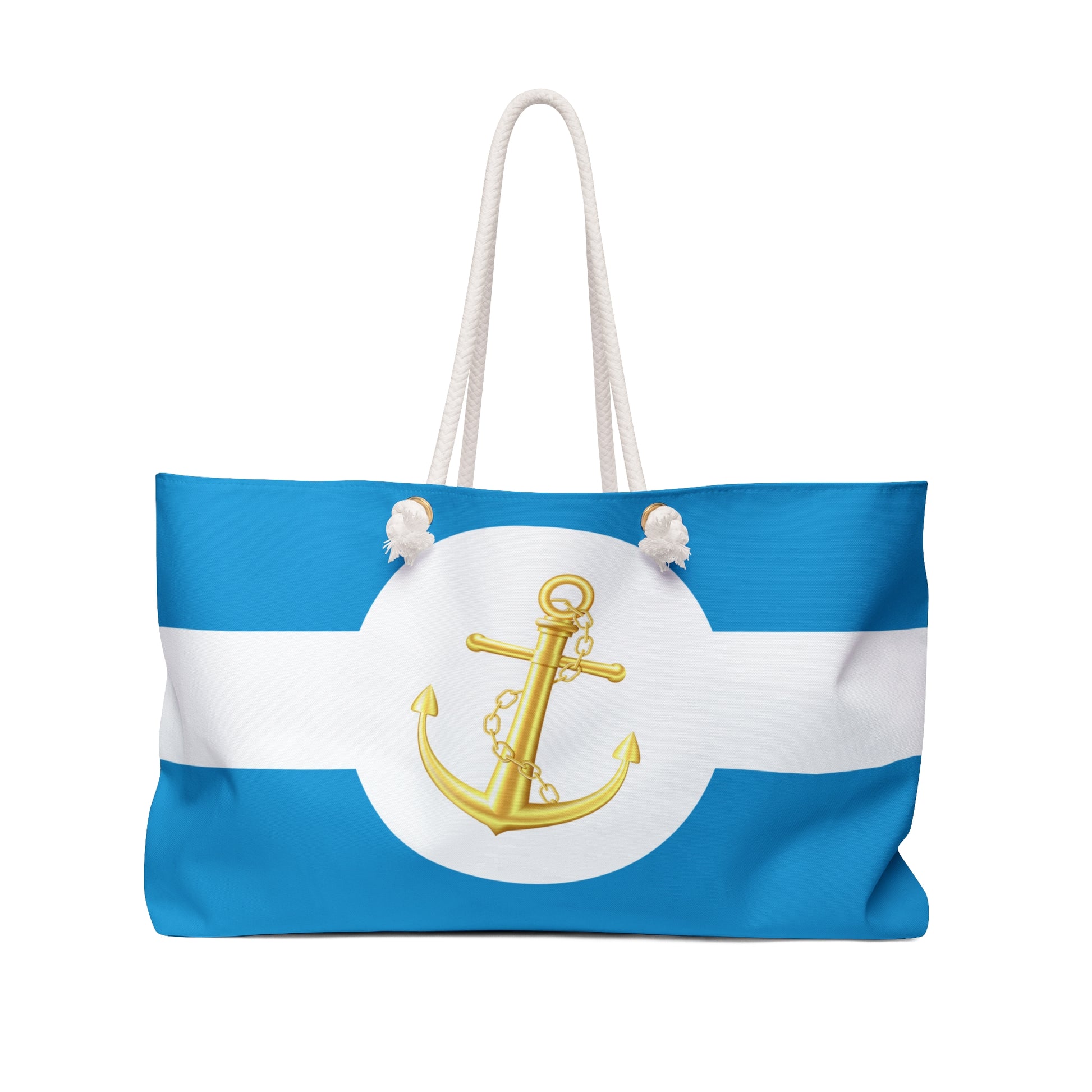 Front view of blue-and-white striped nautical beach tote with shiny gold anchor in white circle, cream rope handles slung high