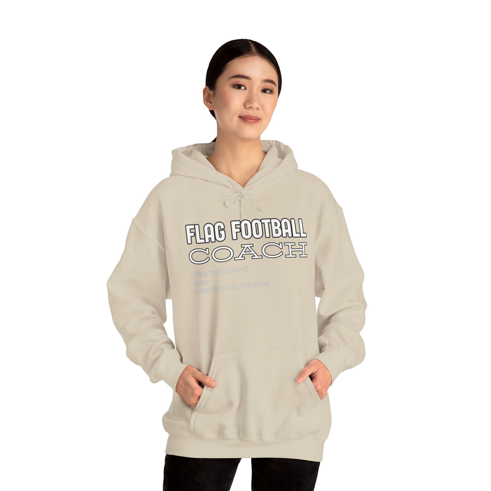 Asian female model in front-view sand Flag Football Coach hoodie, hands in kangaroo pocket, coach vibes