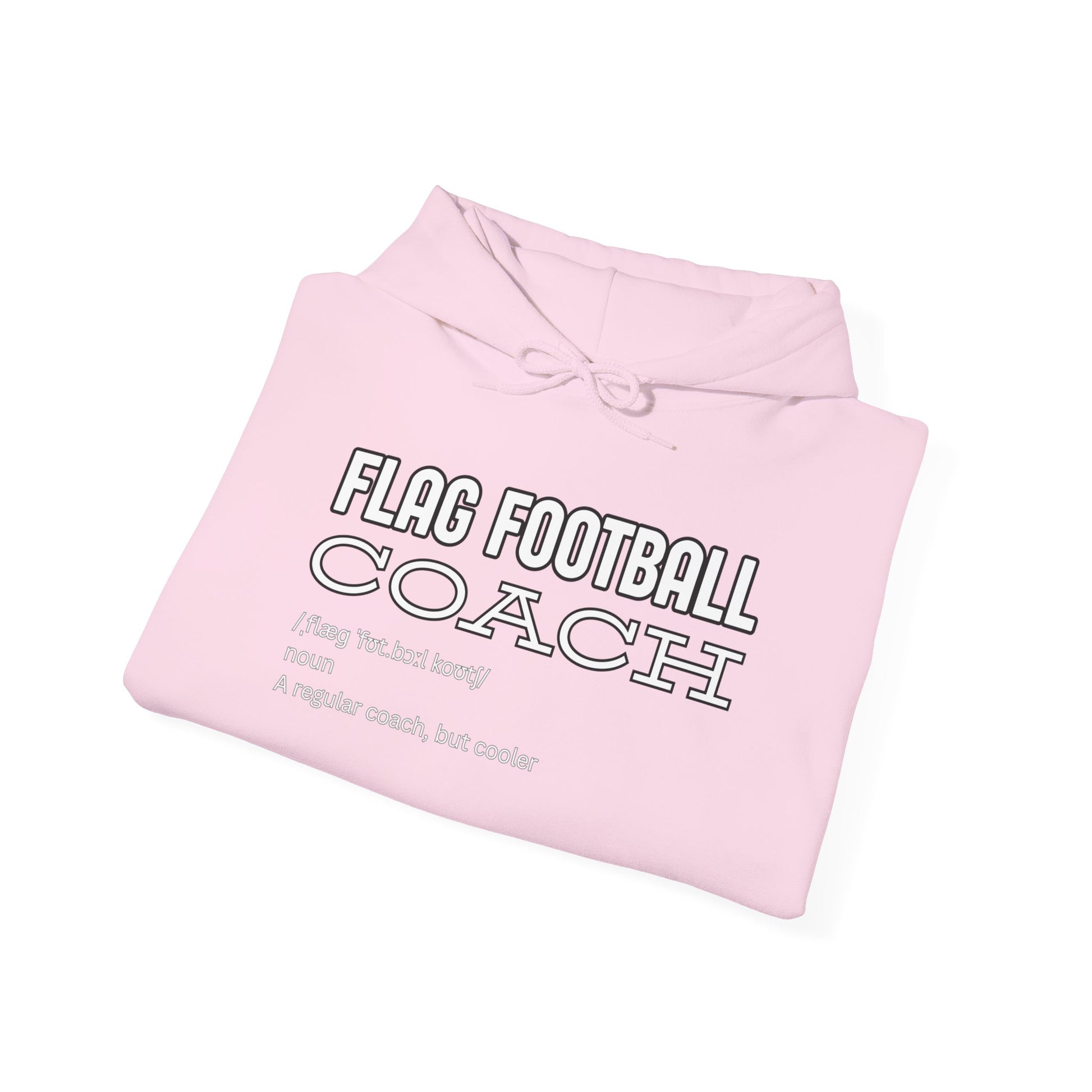 Folded light pink hoodie revealing black front print: "FLAG FOOTBALL COACH (flag foot coach) noun: A regular coach, but cooler"