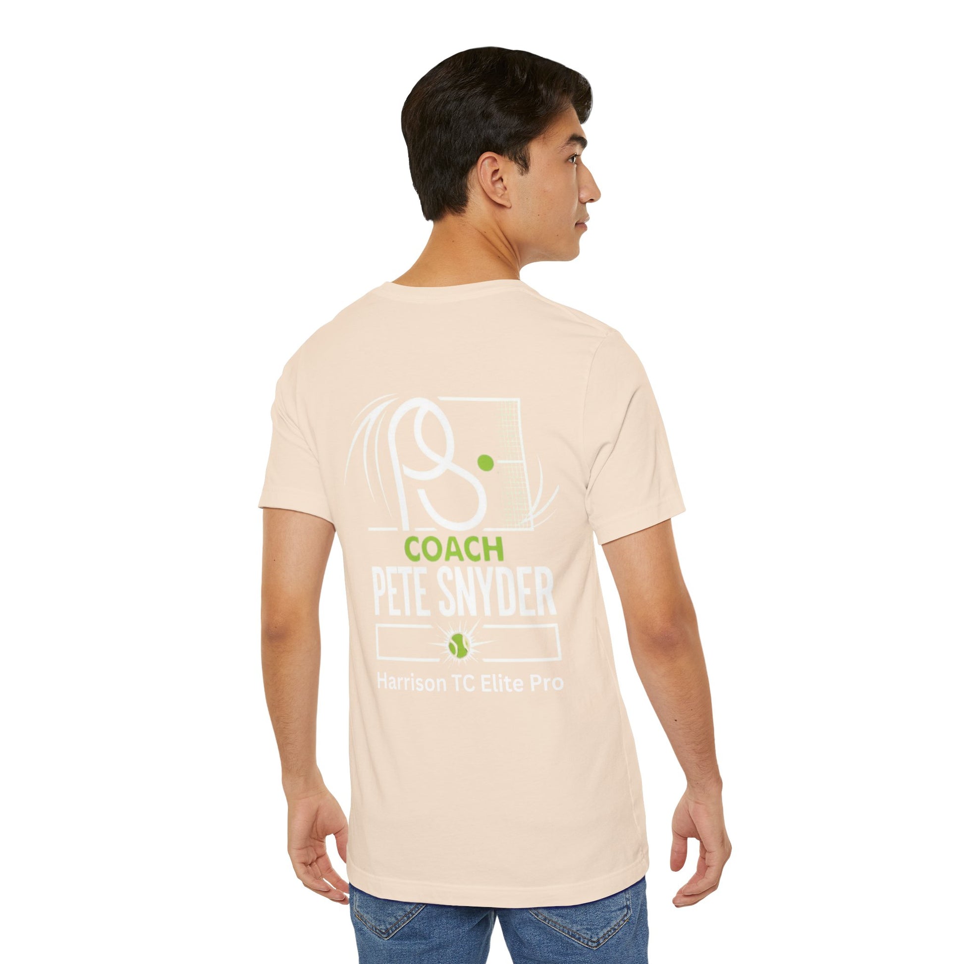 Side profile male model in beige Coach Pete Snyder tee showing back "COACH PETE SNYDER" graphic and jeans