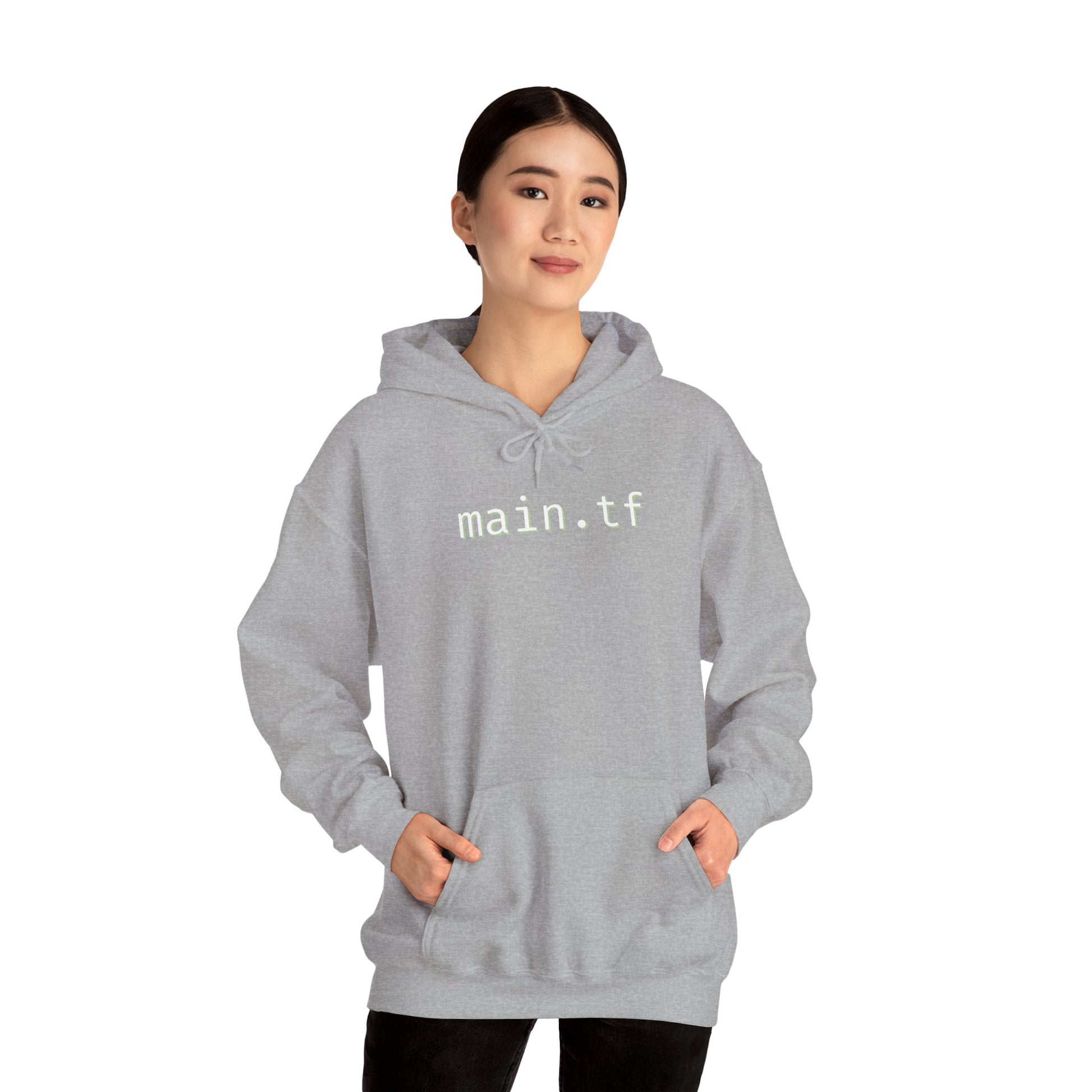 Asian model owning light grey main.tf hoodie front, hands in pockets, casual black pants