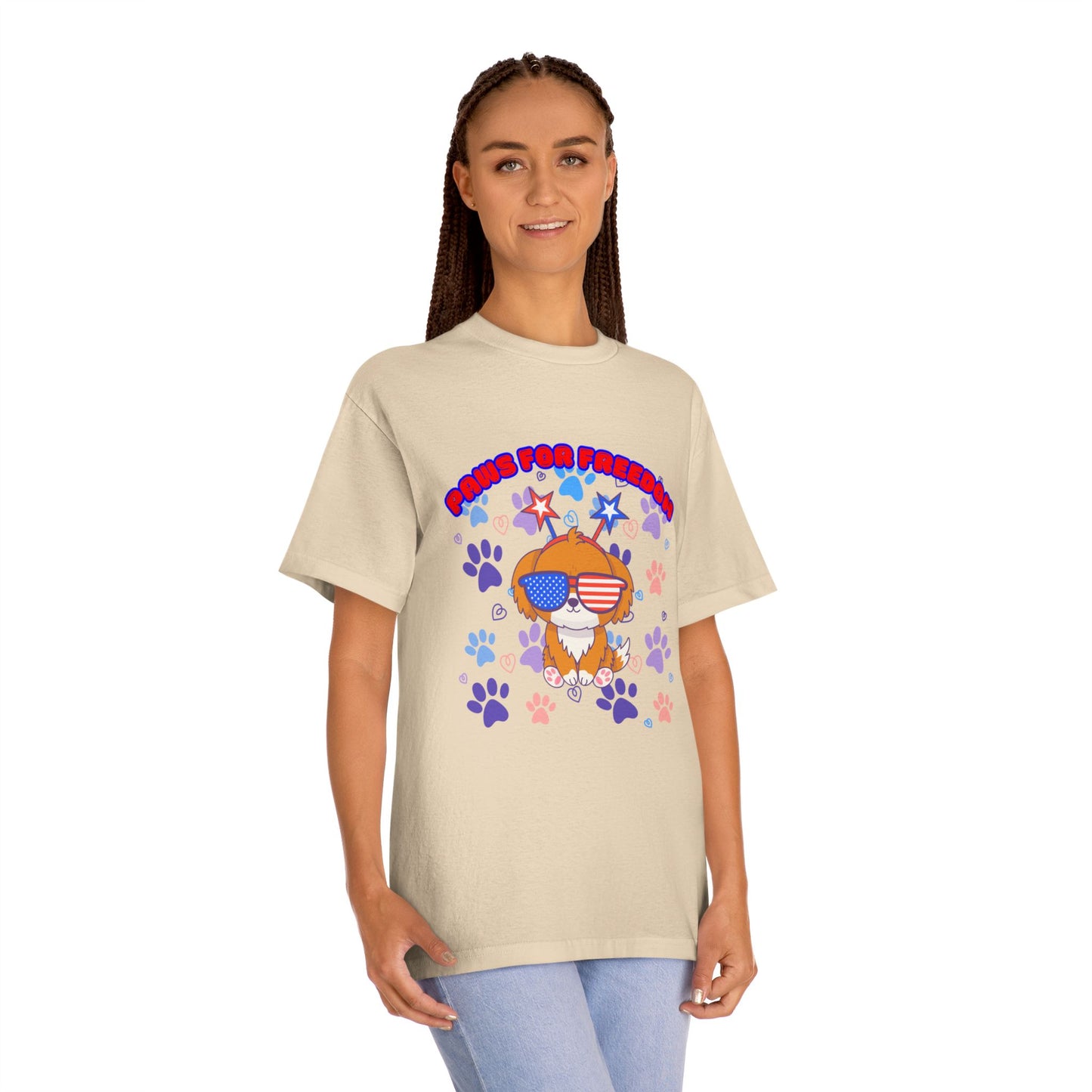 Woman modeling cream 'Paws for Freedom' tee front, doggo with flag shades & colorful patriotic flair