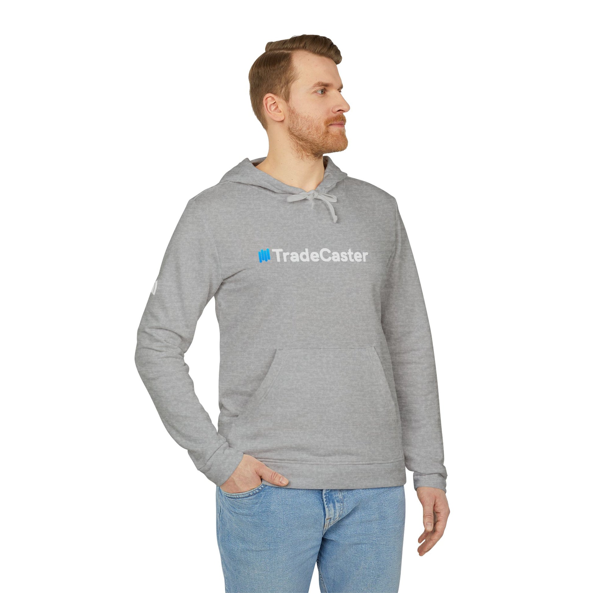 Man side view of grey heather TradeCaster Adidas hoodie, blue "Trade" accent logo, relaxed jeans fit