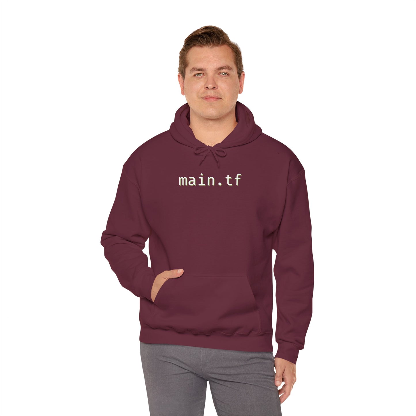 Male model rocking front view of maroon "main.tf" hoodie, one hand in pocket