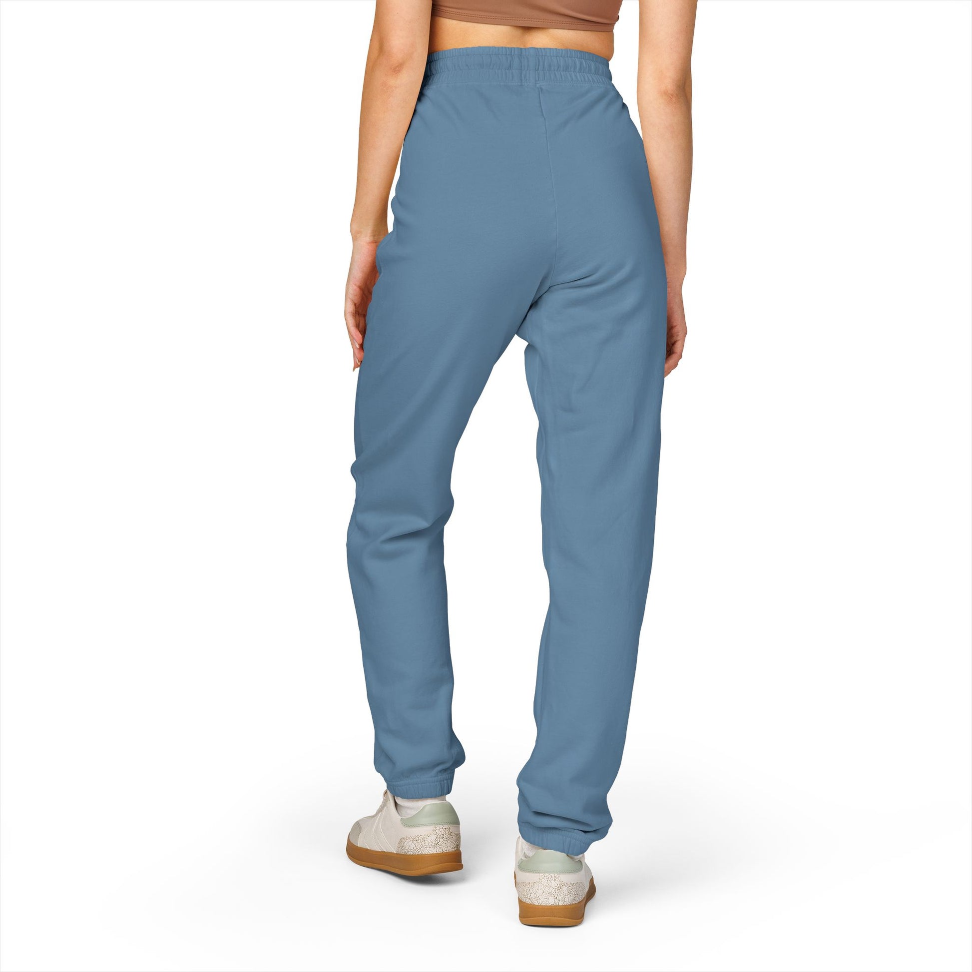 Back view of model in medium blue garment-dyed fleece sweatpants, chill relaxed silhouette