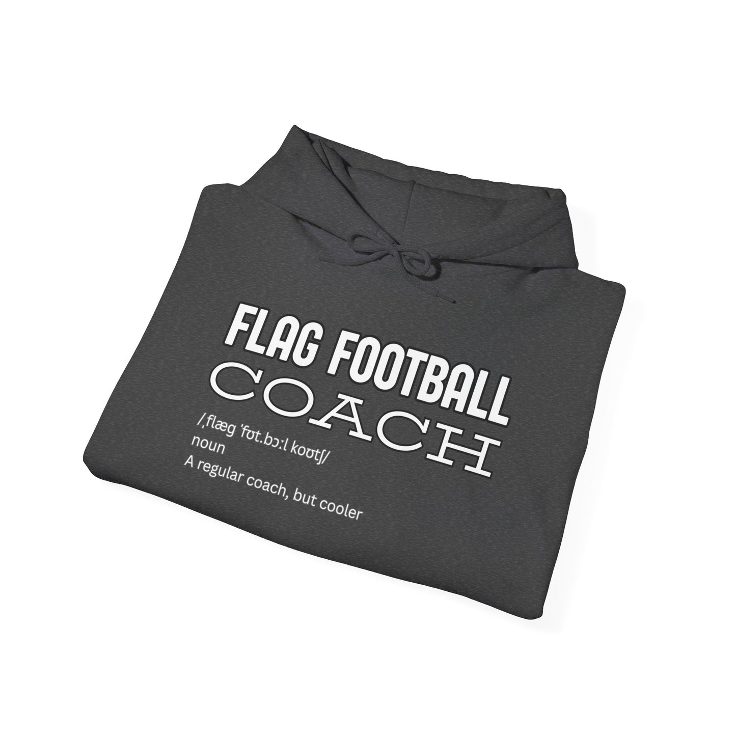 Folded black hoodie showing white "Flag Football Coach: regular coach but cooler" definition print