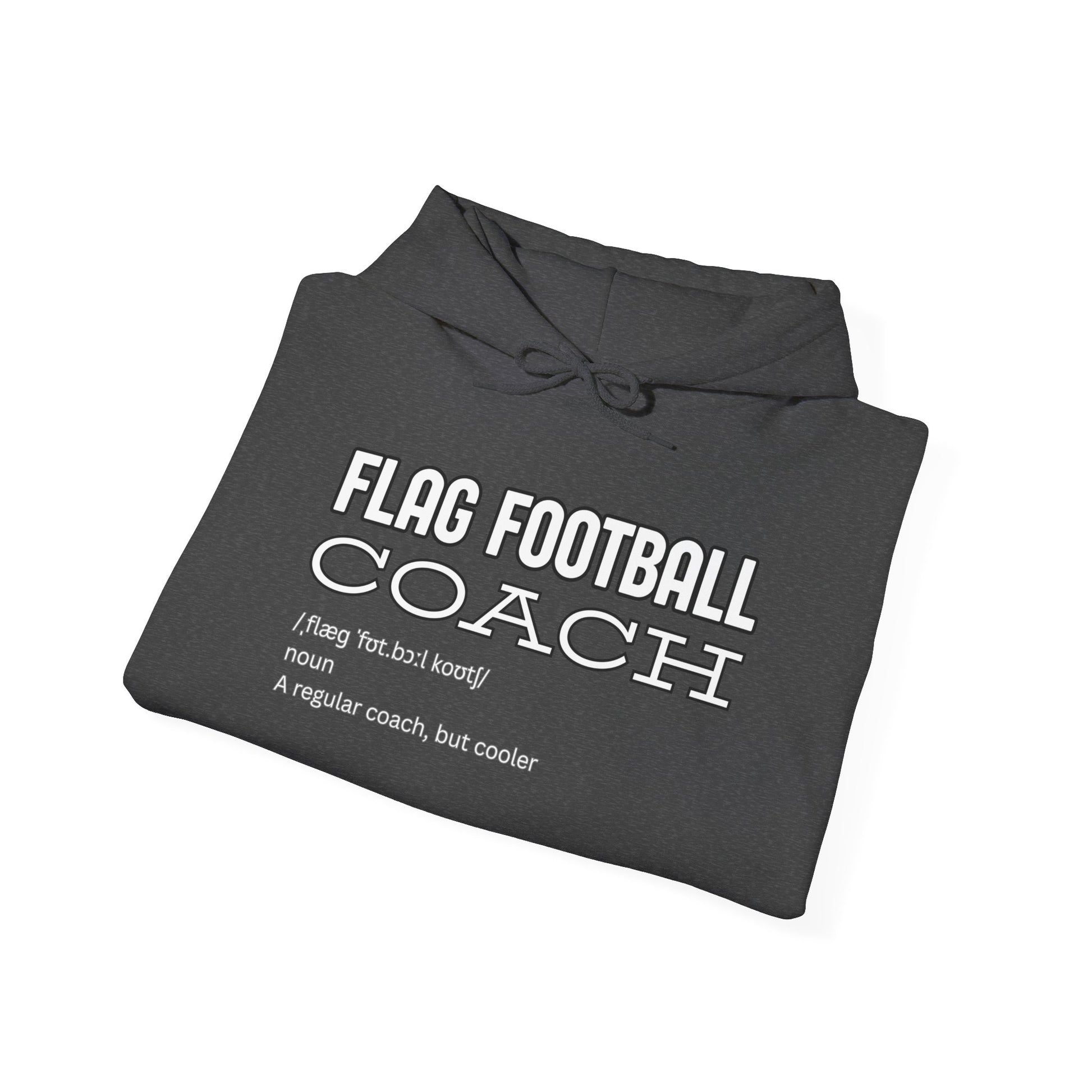 Folded black hoodie showing white "Flag Football Coach: regular coach but cooler" definition print
