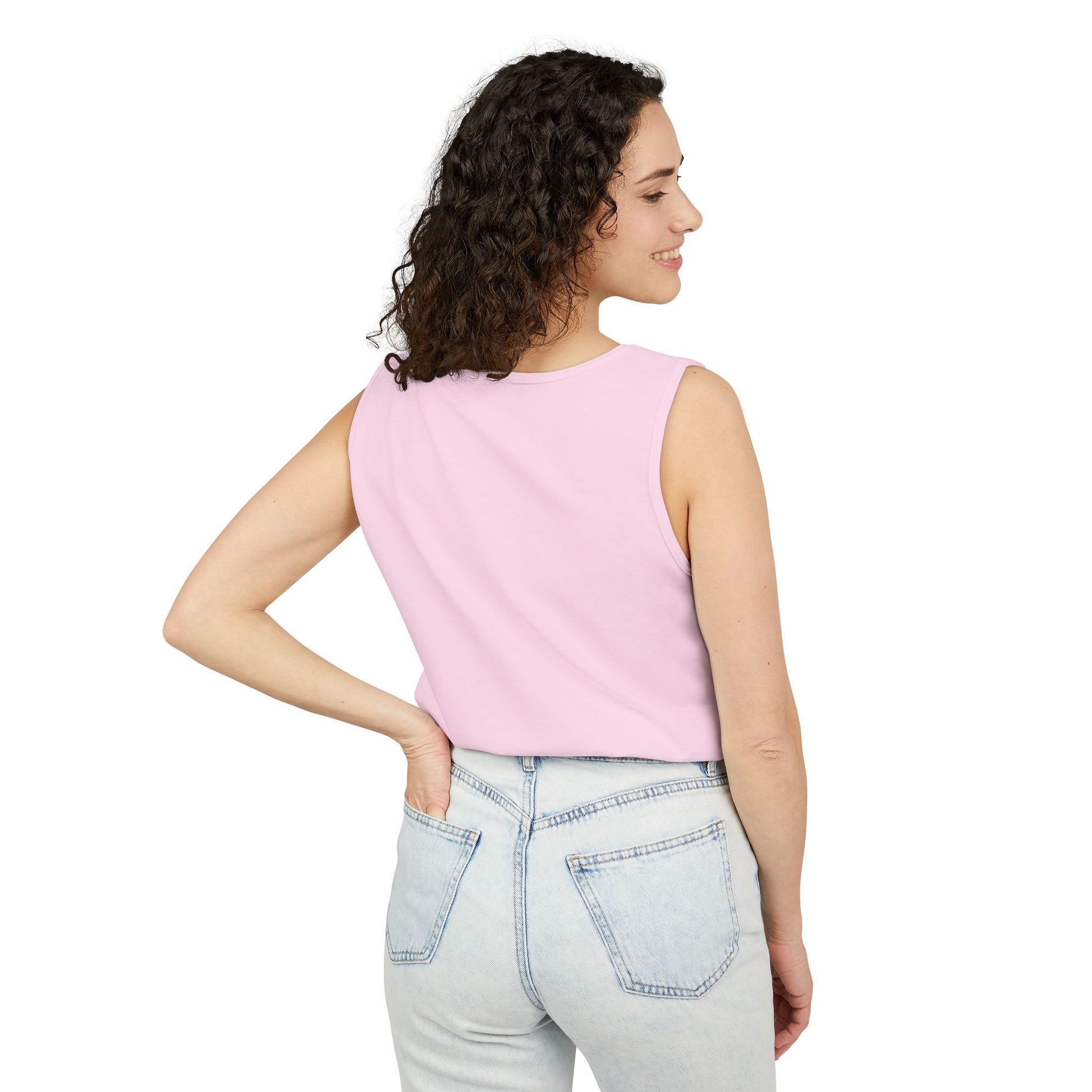 Side profile of woman in plain light pink tank top with light wash jeans