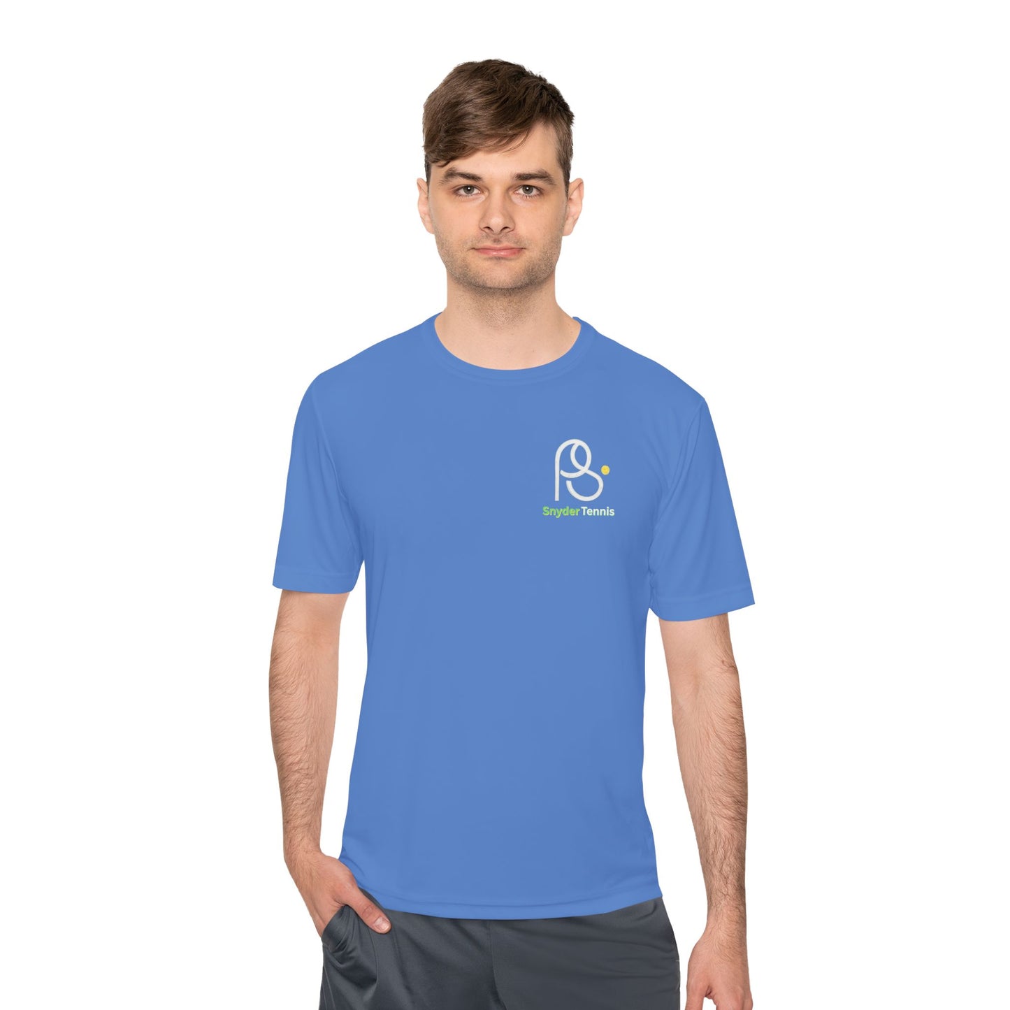 Male model in atomic blue moisture-wicking tee, crisp white PS emblem and green "Bridge Tennis"