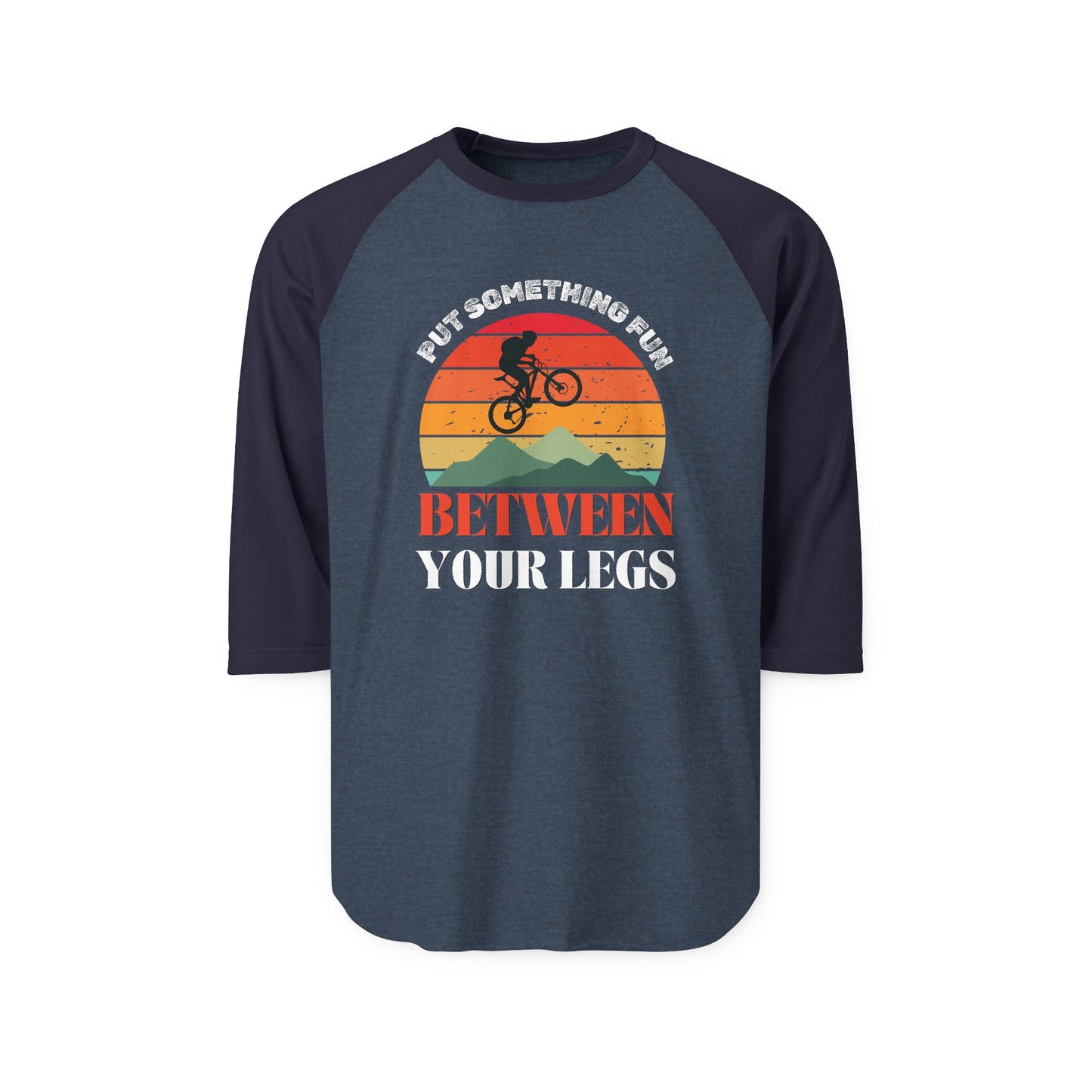 Front of navy raglan tee with black sleeves, bold "Put something fun between your legs" and orange sunset MTB silhouette