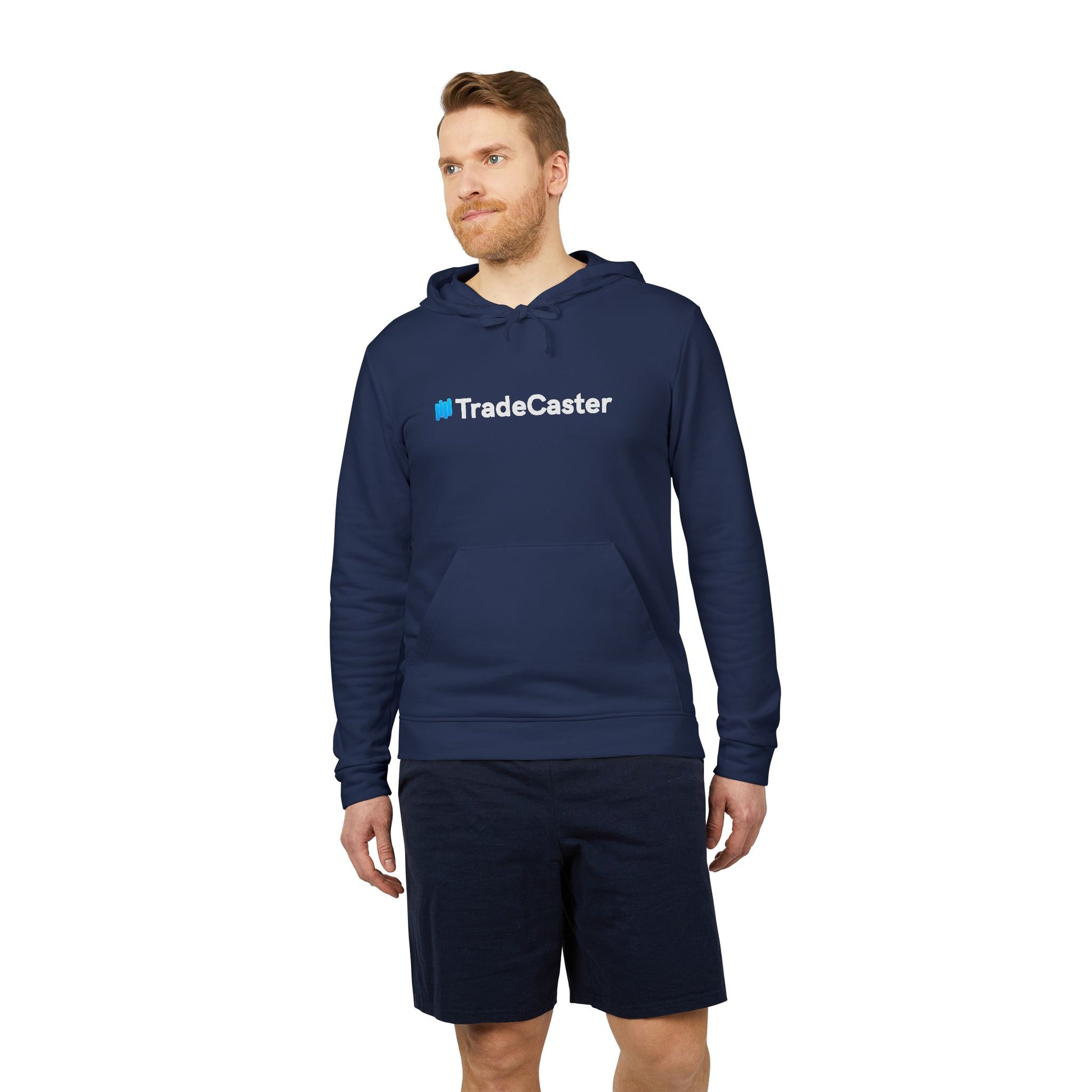 Ginger dude looking up in navy Adidas fleece hoodie, white #TradeCaster print popping on chest, dark shorts