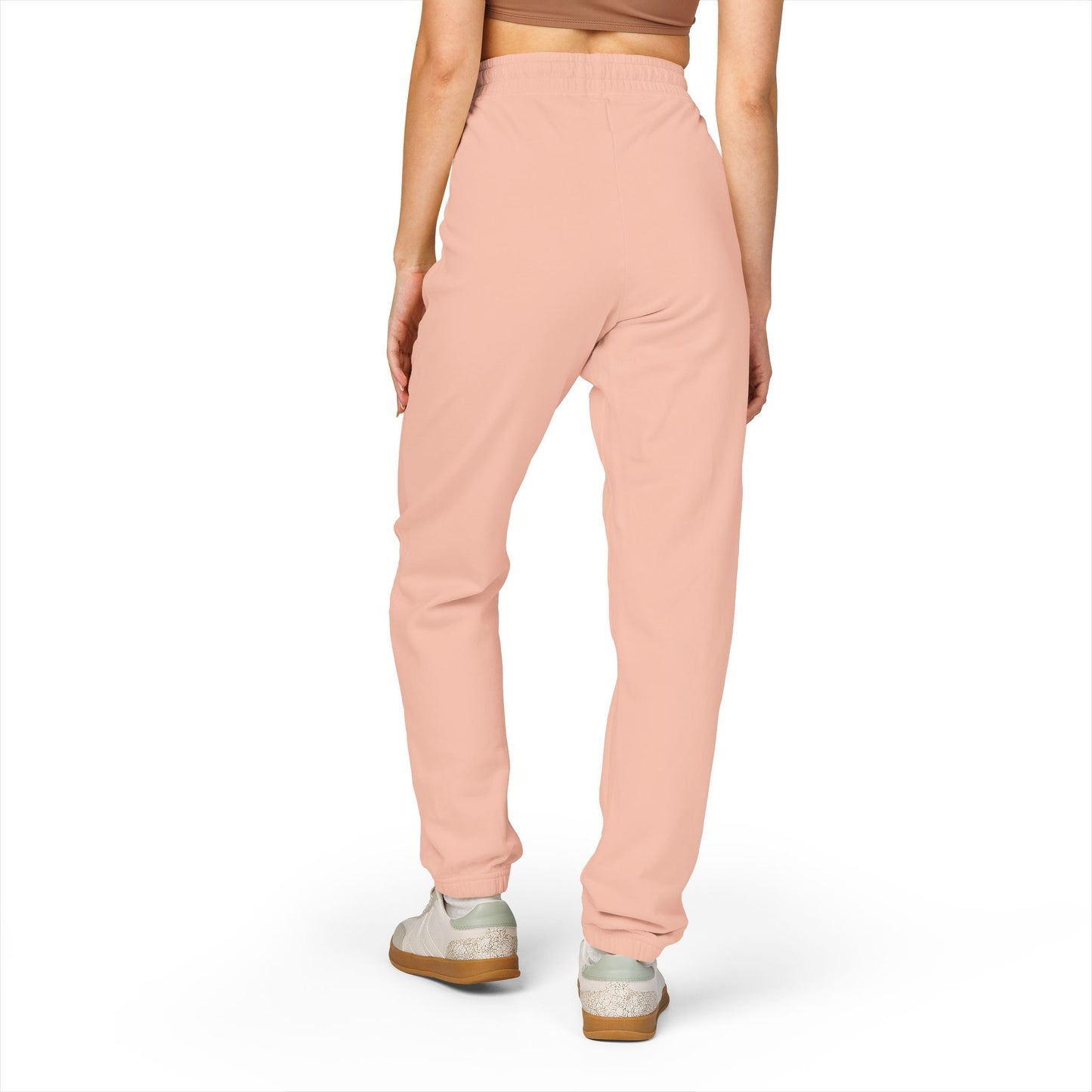 Model back view in peachy Zeta joggers, relaxed taper, white sneakers — effortless cozy
