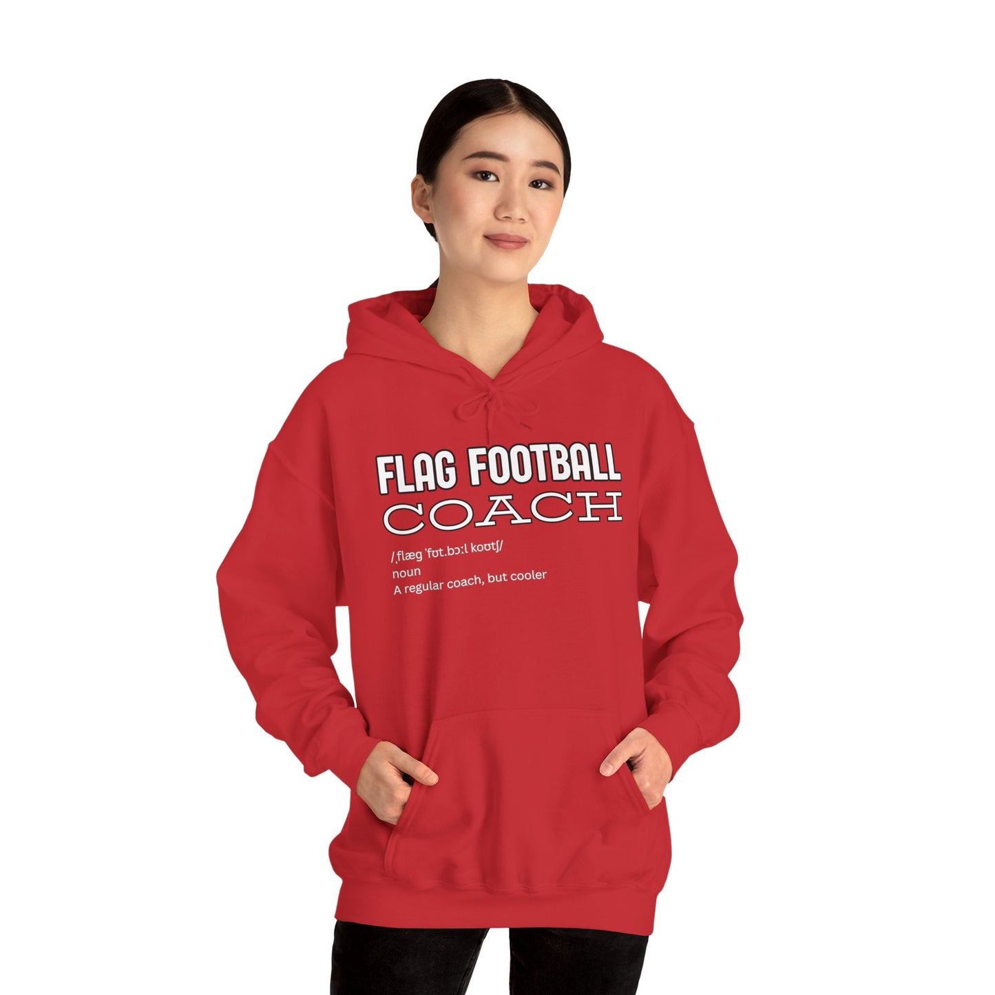 Female model in front-facing red hoodie with white "Flag Football Coach" text, hands in kangaroo pockets