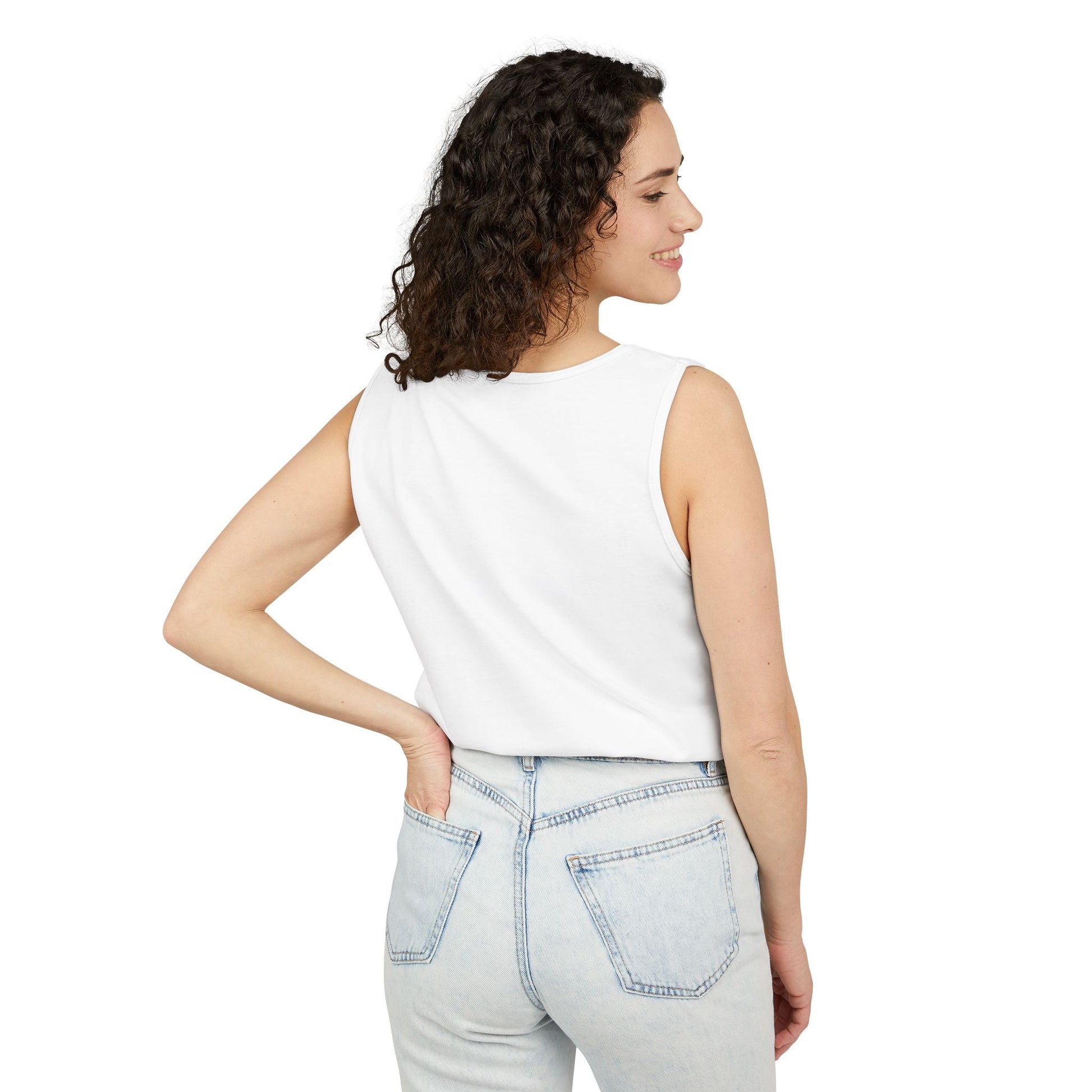 Back view of woman in plain white tank, hand on hip over light wash jeans