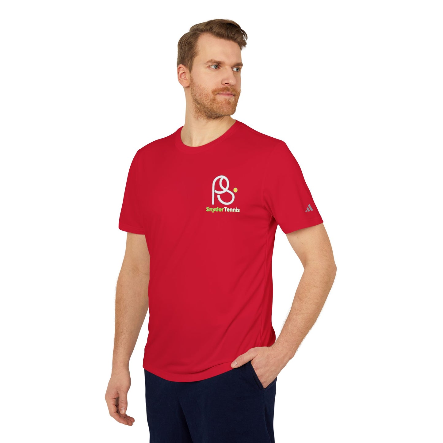 Bearded man in Power Red adidas tee, three-quarter front showing PB Tennis logo, relaxed stance