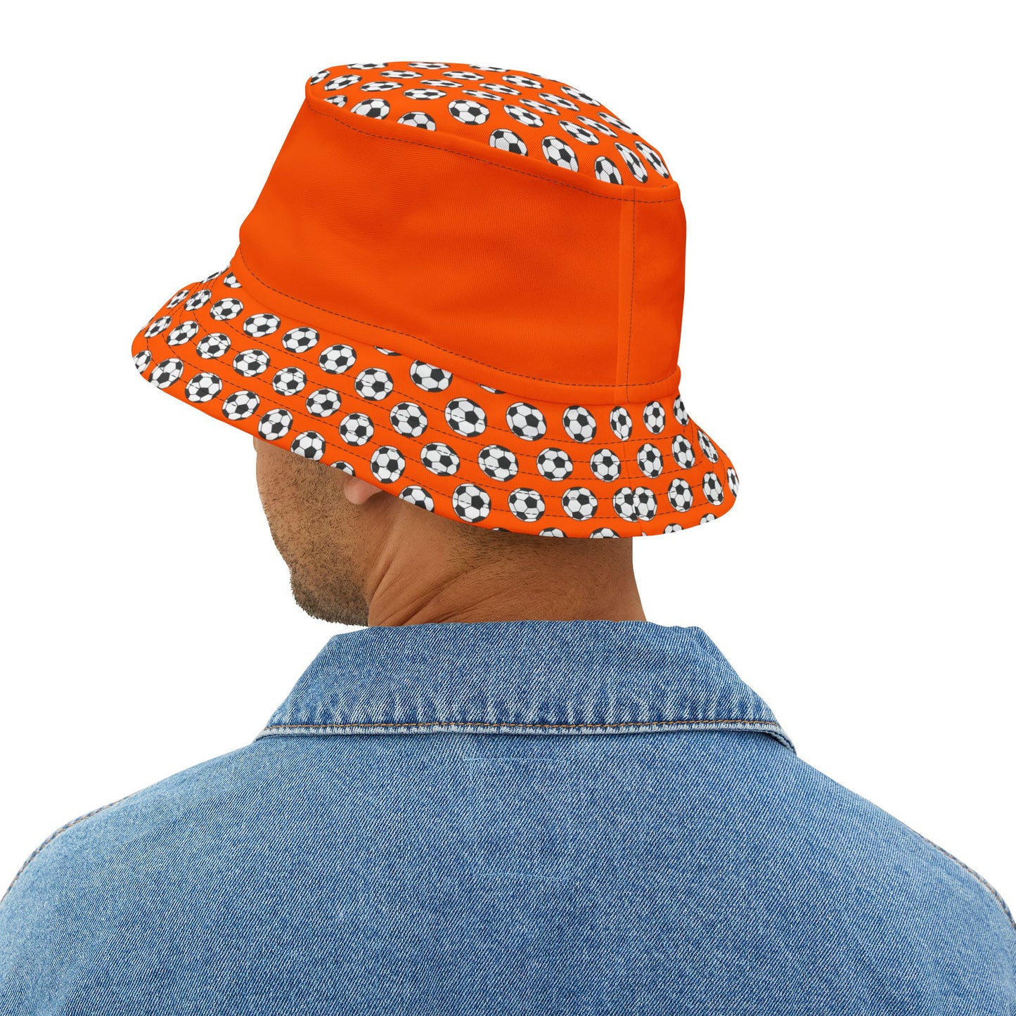 Rear view dude in denim with orange bucket hat, soccer ball brim wrapping all the way around