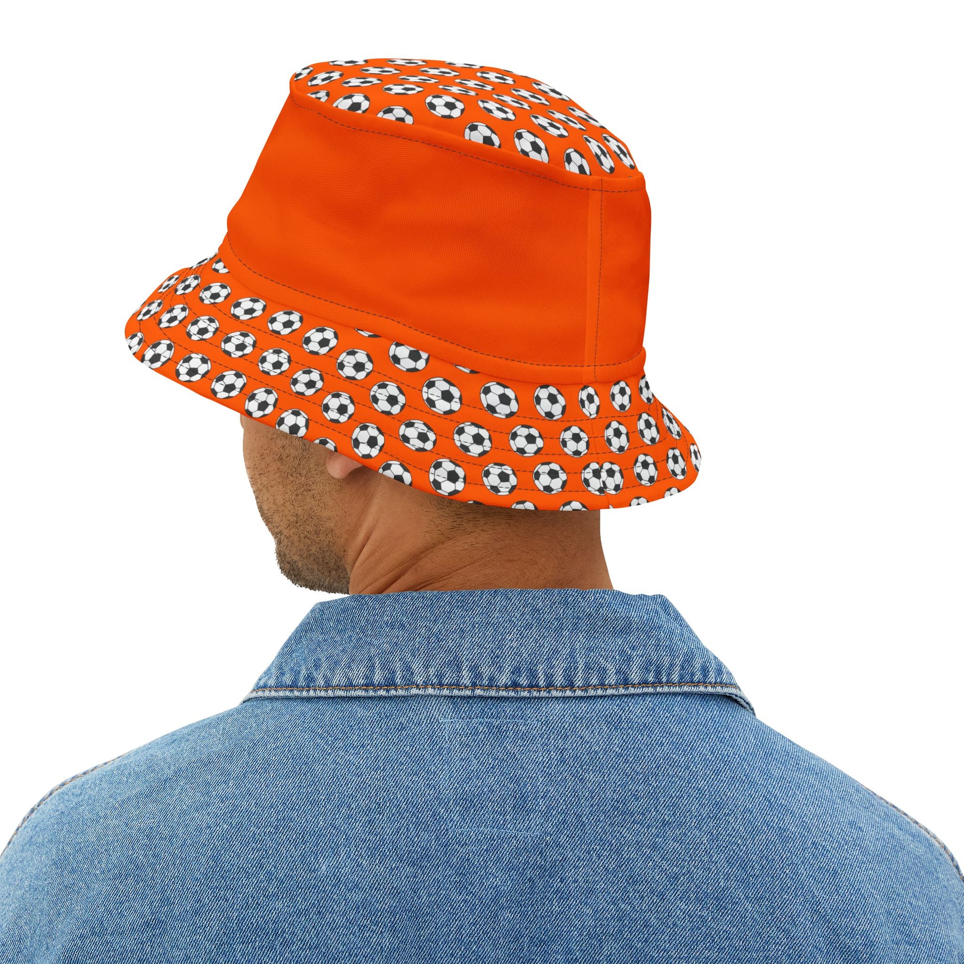 Rear view dude in denim with orange bucket hat, soccer ball brim wrapping all the way around