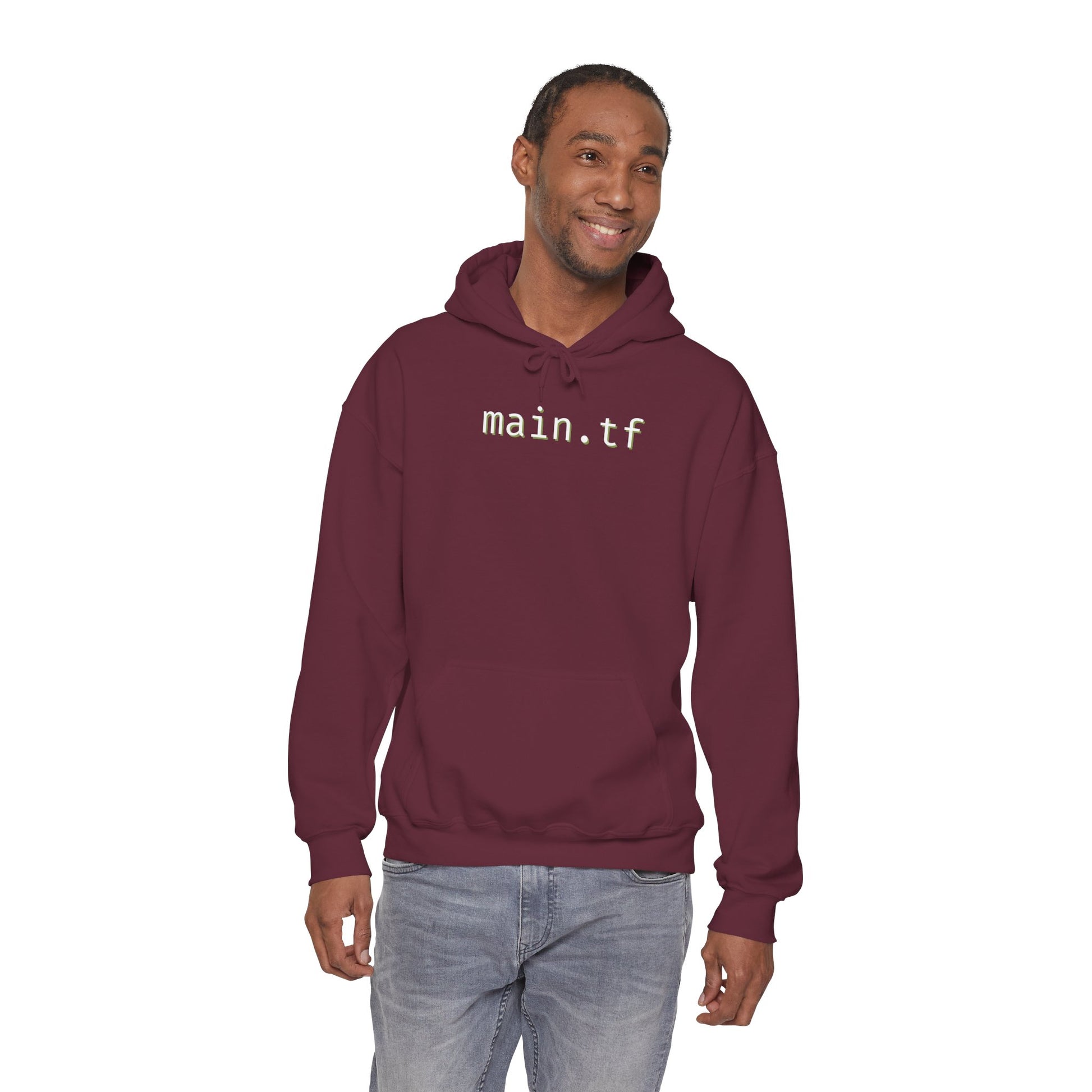 Smiling male model in maroon pullover hoodie with white "main.tf" print