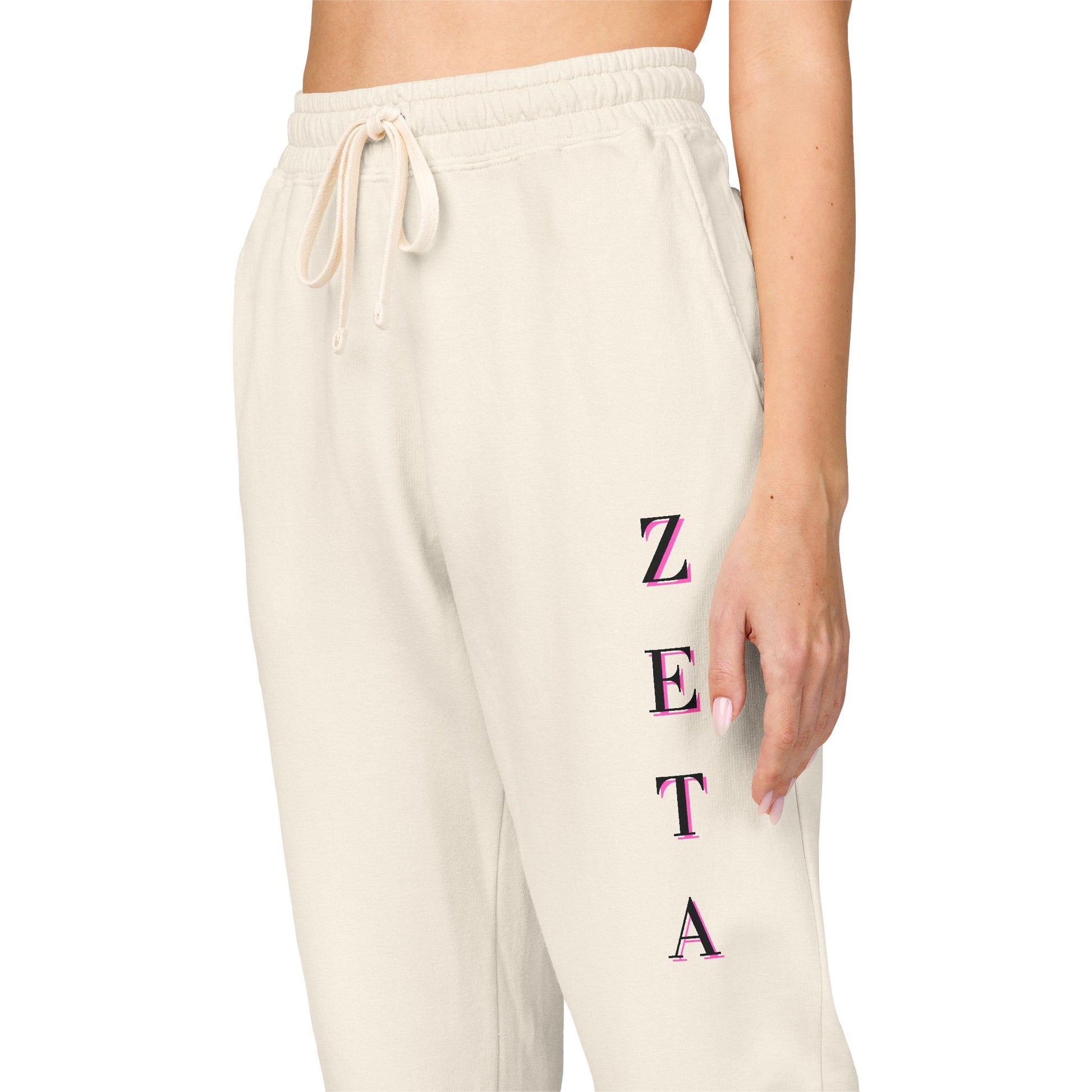 Side view of model in off-white Zeta Vertical Script sweatpants, magenta ZETA embroidery down the leg