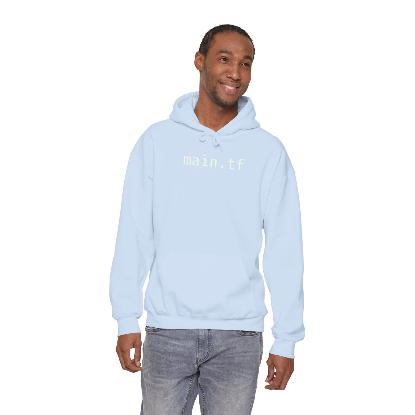 Male model in light blue "main.tf" hoodie, one hand in pocket, grey pants DevOps flex