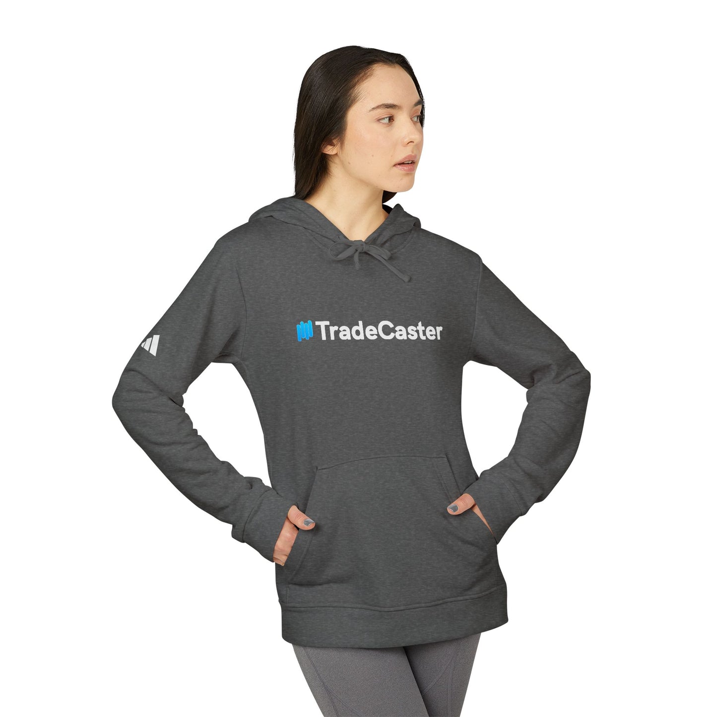 Side view of female model in grey heather TradeCaster hoodie, adidas sleeve logo peeking, poised for trade wins