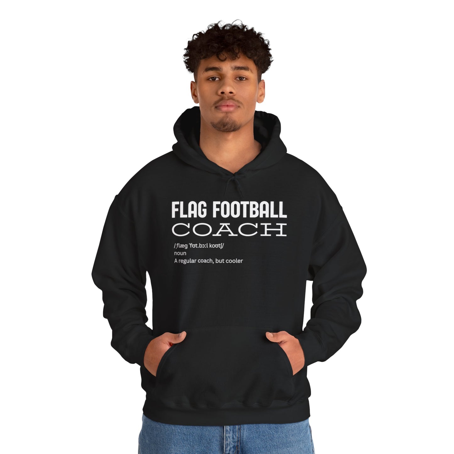 Curly-haired man in black "Flag Football Coach – cooler than regular" hoodie, front pose