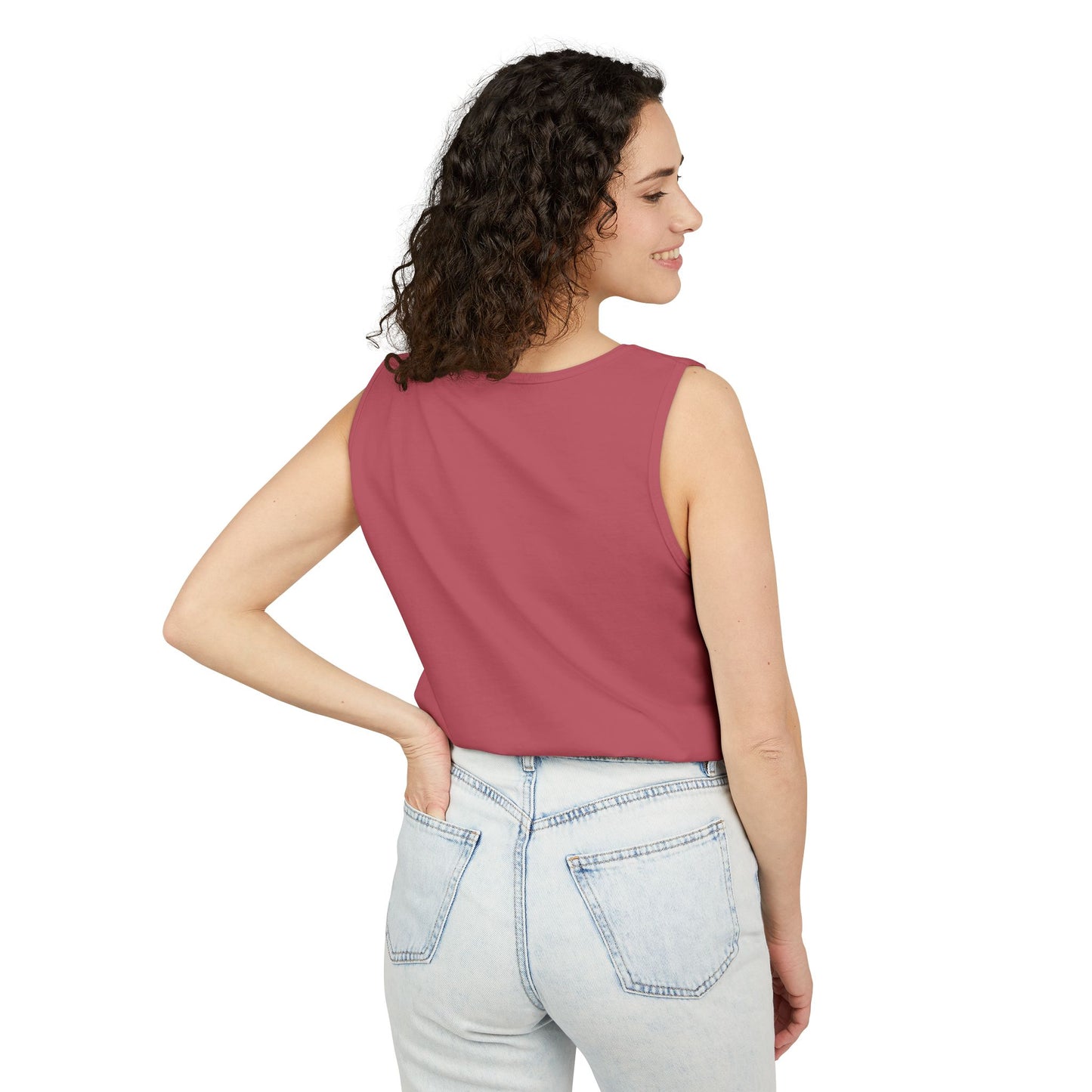 Right side view of smiling curly-haired woman in hot pink tank top and light wash jeans