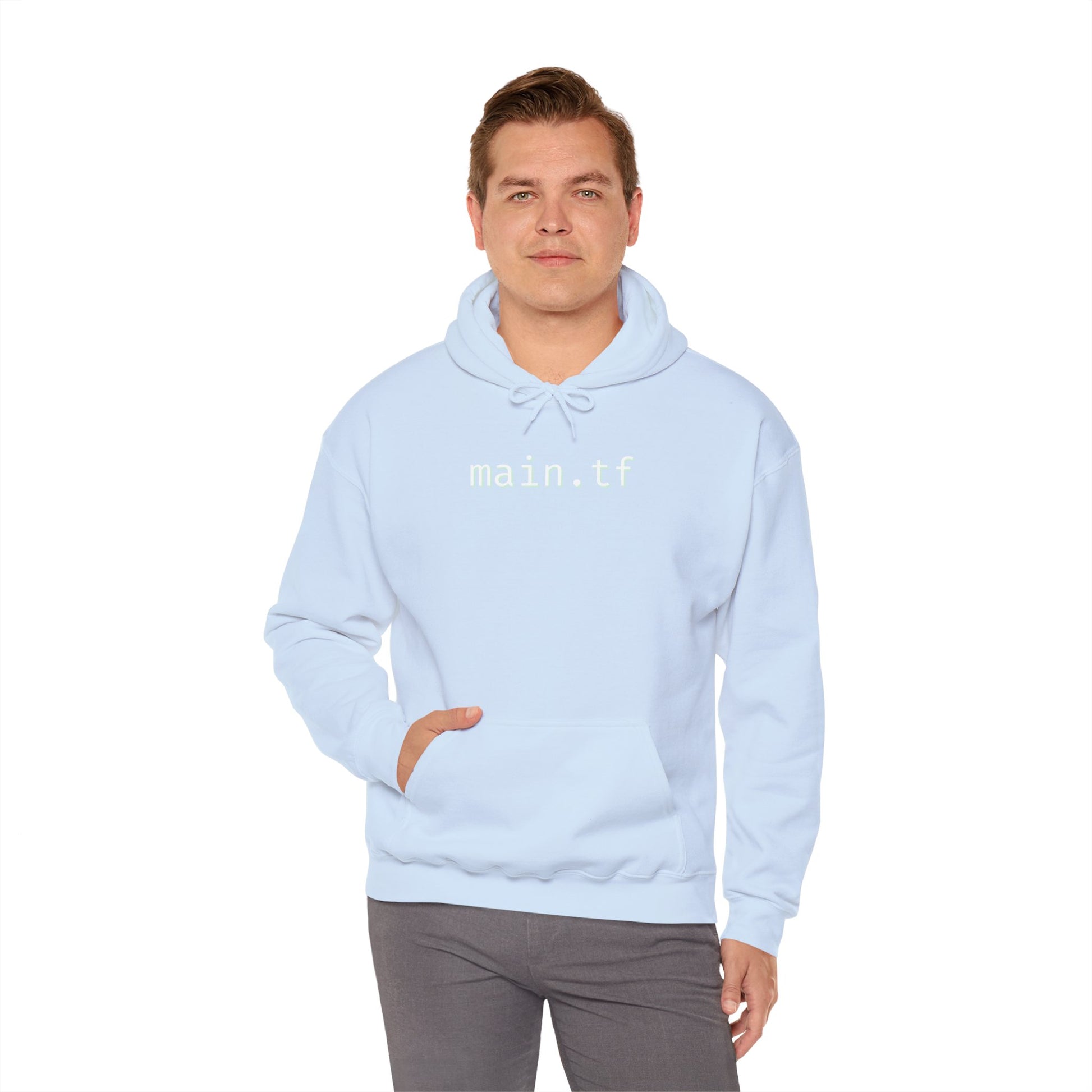 Curly-haired male model rocking light blue "main.tf" hoodie front view, hands out, jeans casual