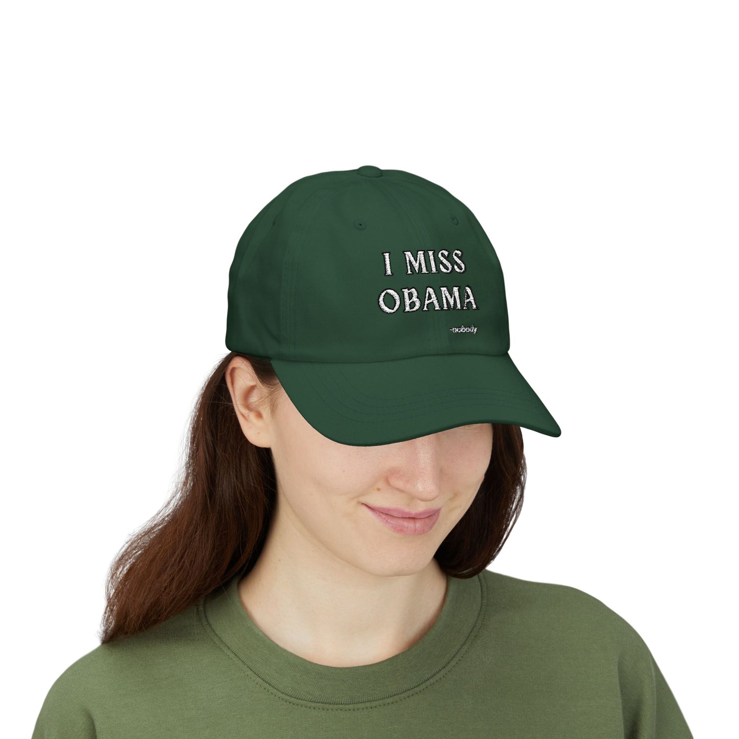 Woman model in green top rocking spruce green "I MISS OBAMA -nobody" dad hat, front embroidered view