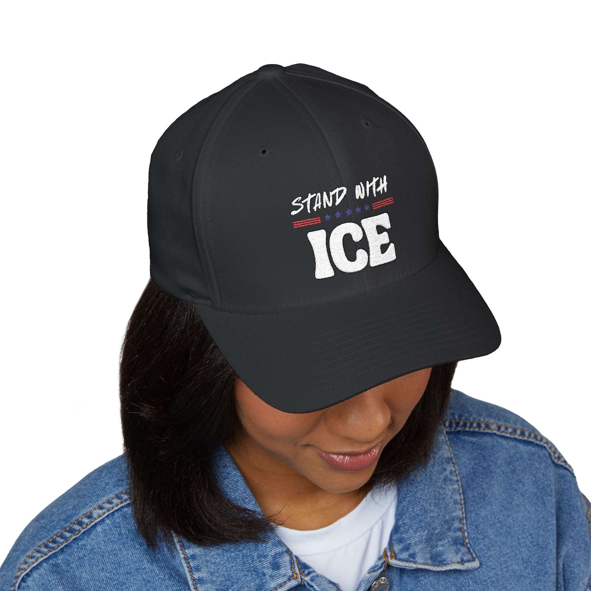 Woman modeling black "Stand With ICE" cap at angle, embroidery visible with red/blue accents, denim jacket vibe