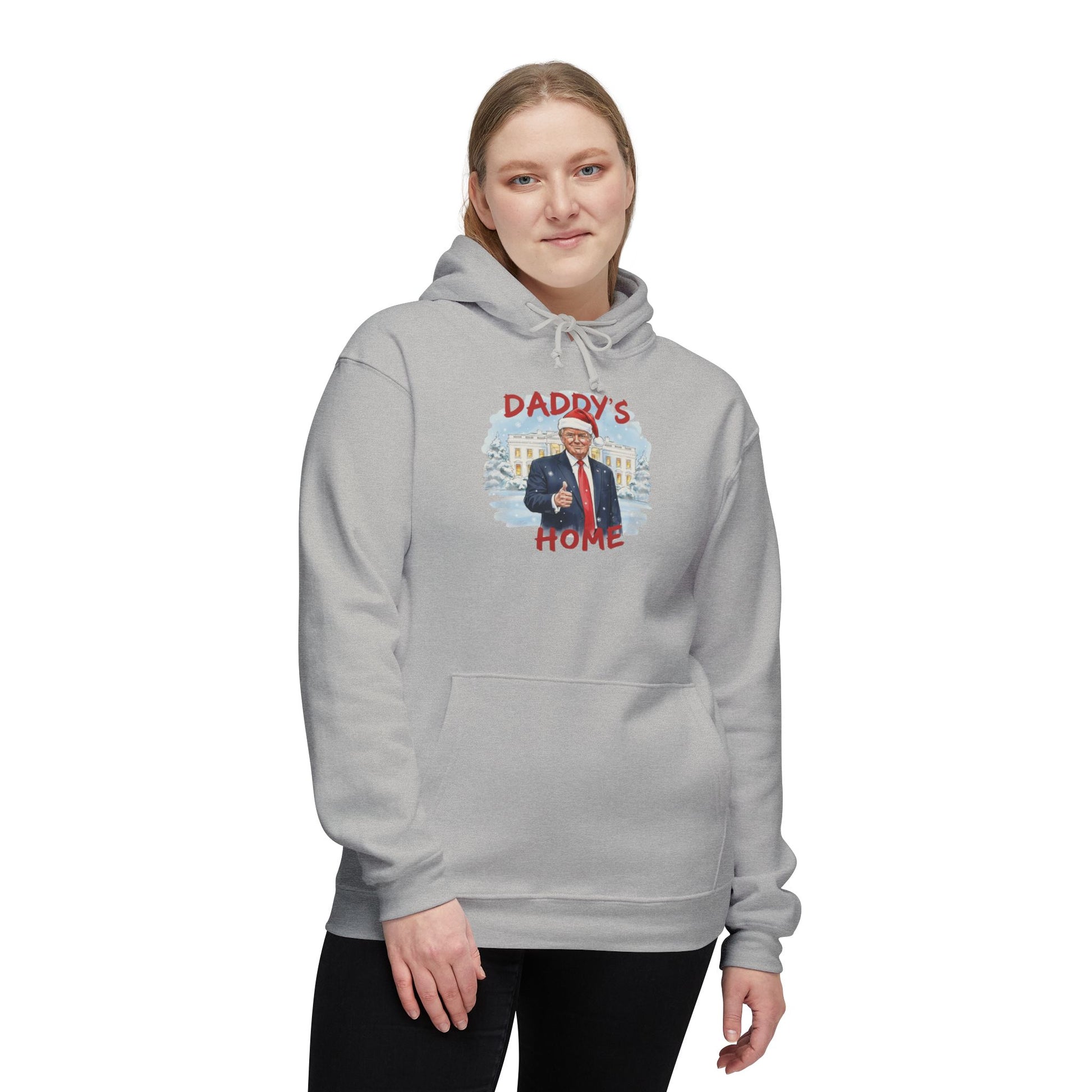 Woman in heather gray "Daddy's Home" Trump Christmas hoodie front view, Santa-hatted Trump pointing at snowy White House