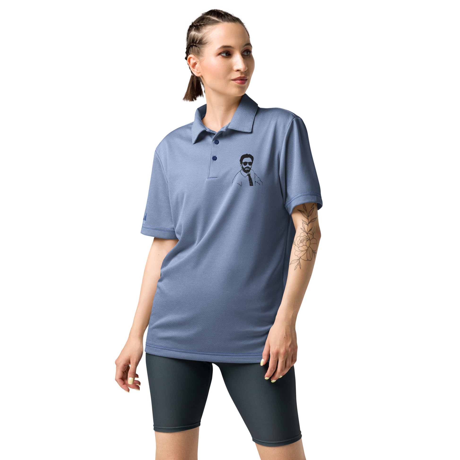 Braided woman side view in light heather blue-grey Adidas polo with black Burry embroidery, dark shorts