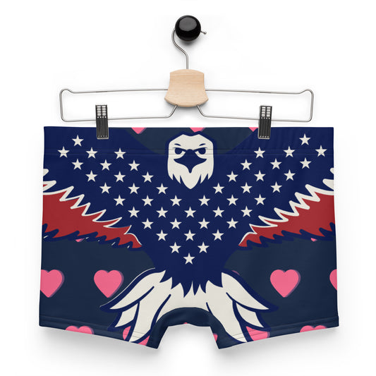 Front flat view on hanger of navy boxer briefs with bold white eagle head, stars, red wings, scattered pink hearts