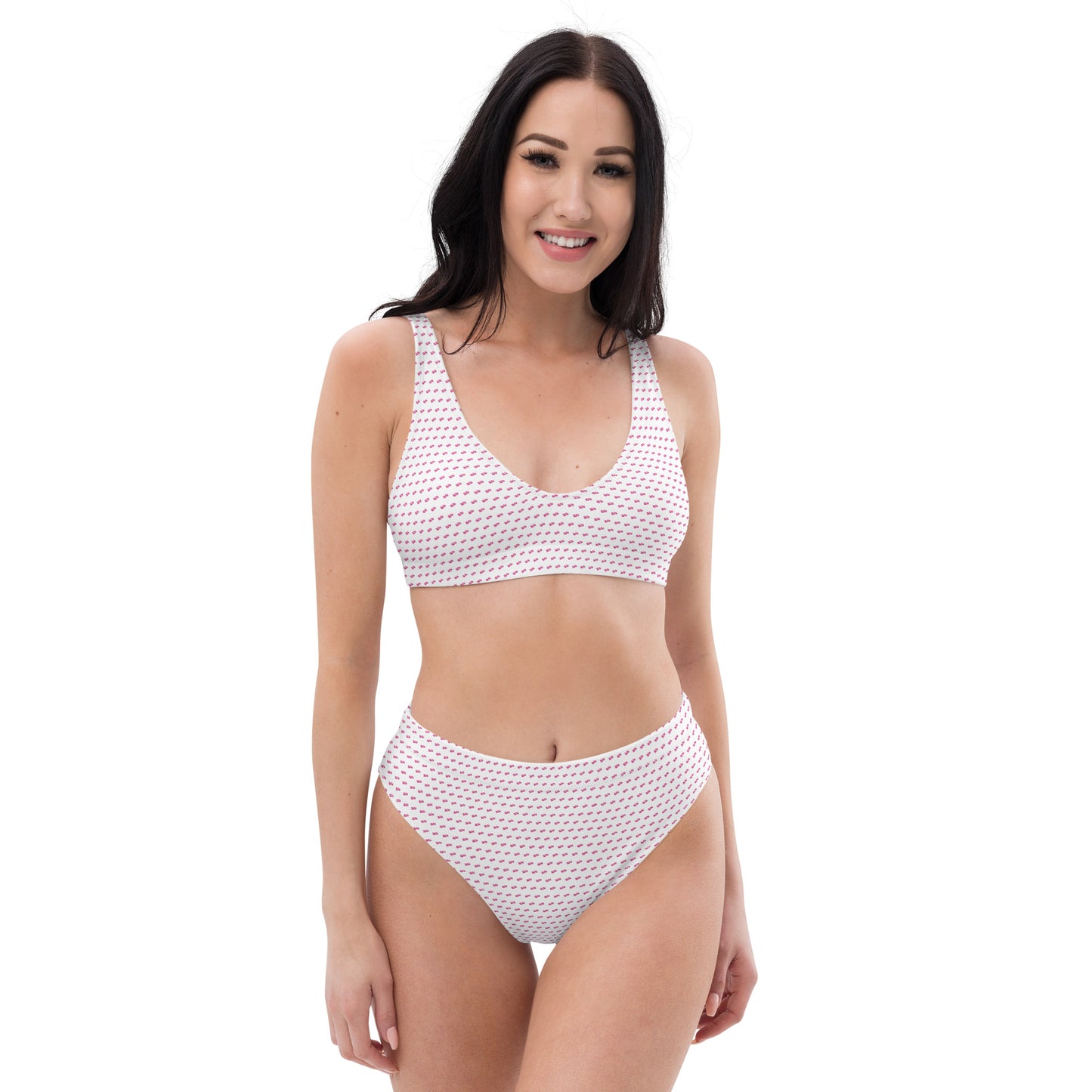 Front view of smiling model slaying in white recycled bikini with all-over pink pattern