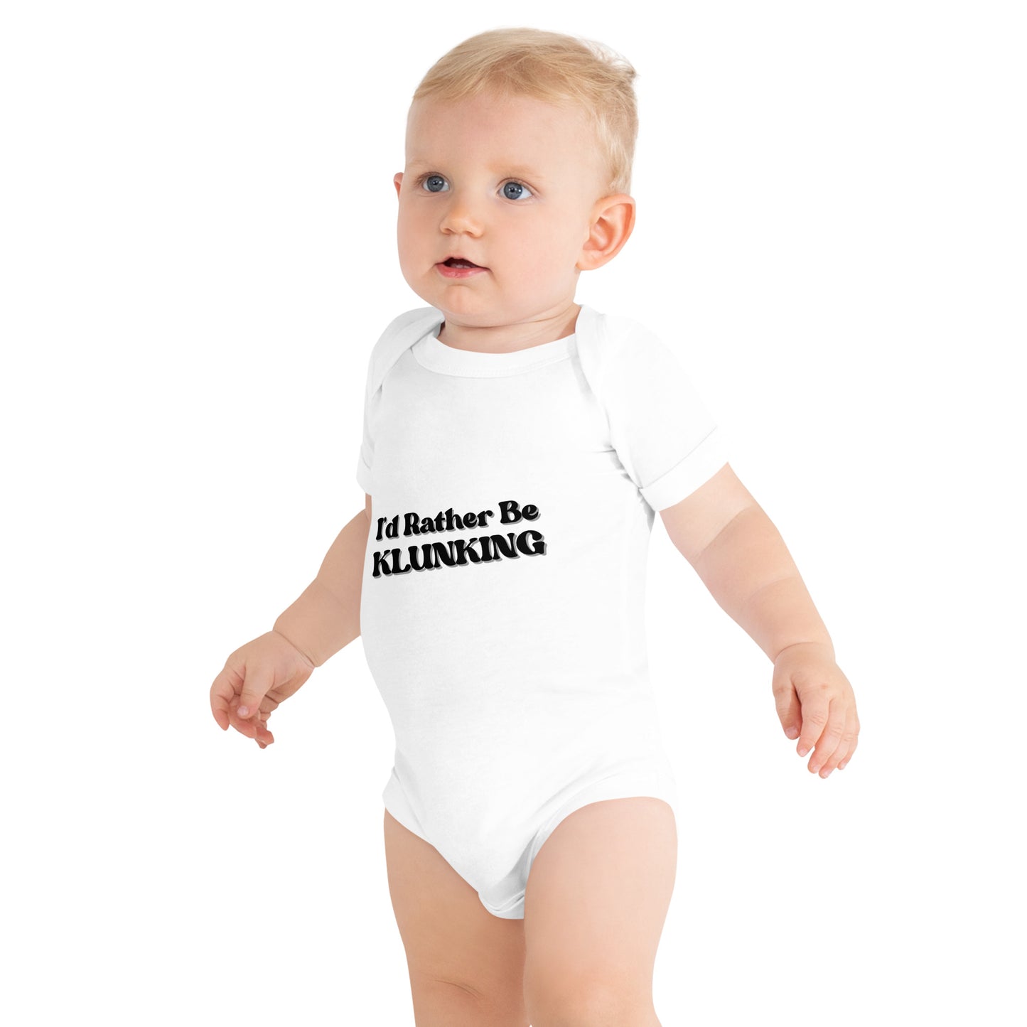 Side view of baby in white "I’d Rather Be KLUNKING" short sleeve baby onesie