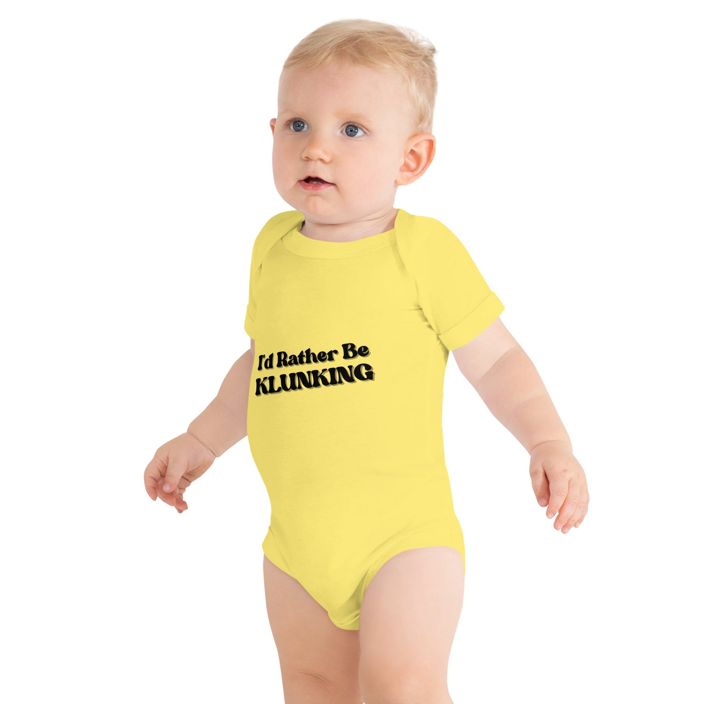 Baby side-walking in sunny yellow "I’d Rather Be KLUNKING" short sleeve onesie