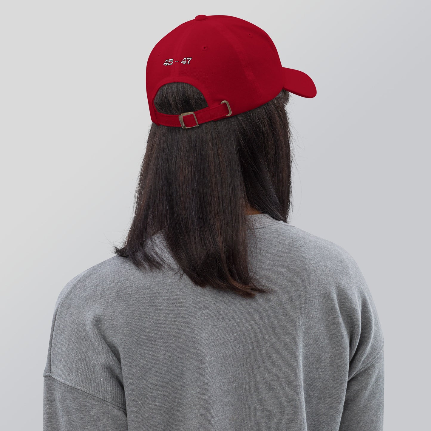 Back view of red dad hat on model in gray top, white "AOC '47" embroidery above adjustable strap