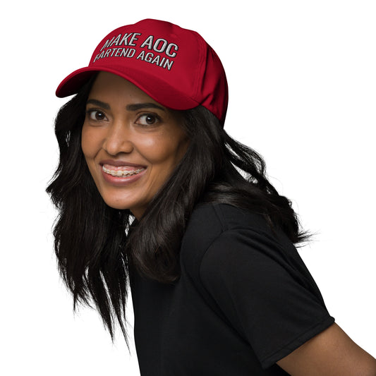Smiling model in black top wearing red dad hat with white "Make AOC Bartend Again" embroidery, front-left view