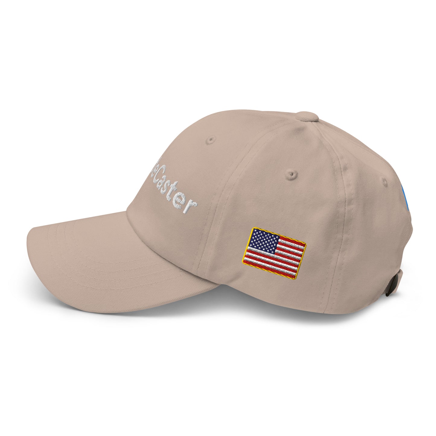 Angled side view of tan cap with "TradeCaster" embroidery, blue bars, and US flag